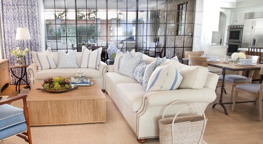 family room in a cozy coastal home featuring white and blue pillows