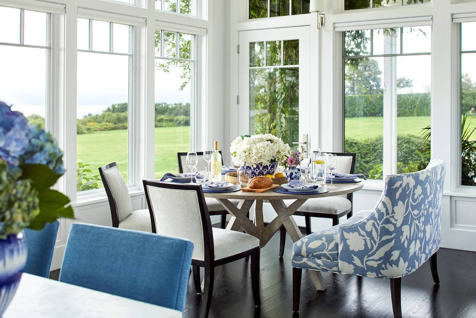 breakfast nook in coastal style home featuring round table and chairs