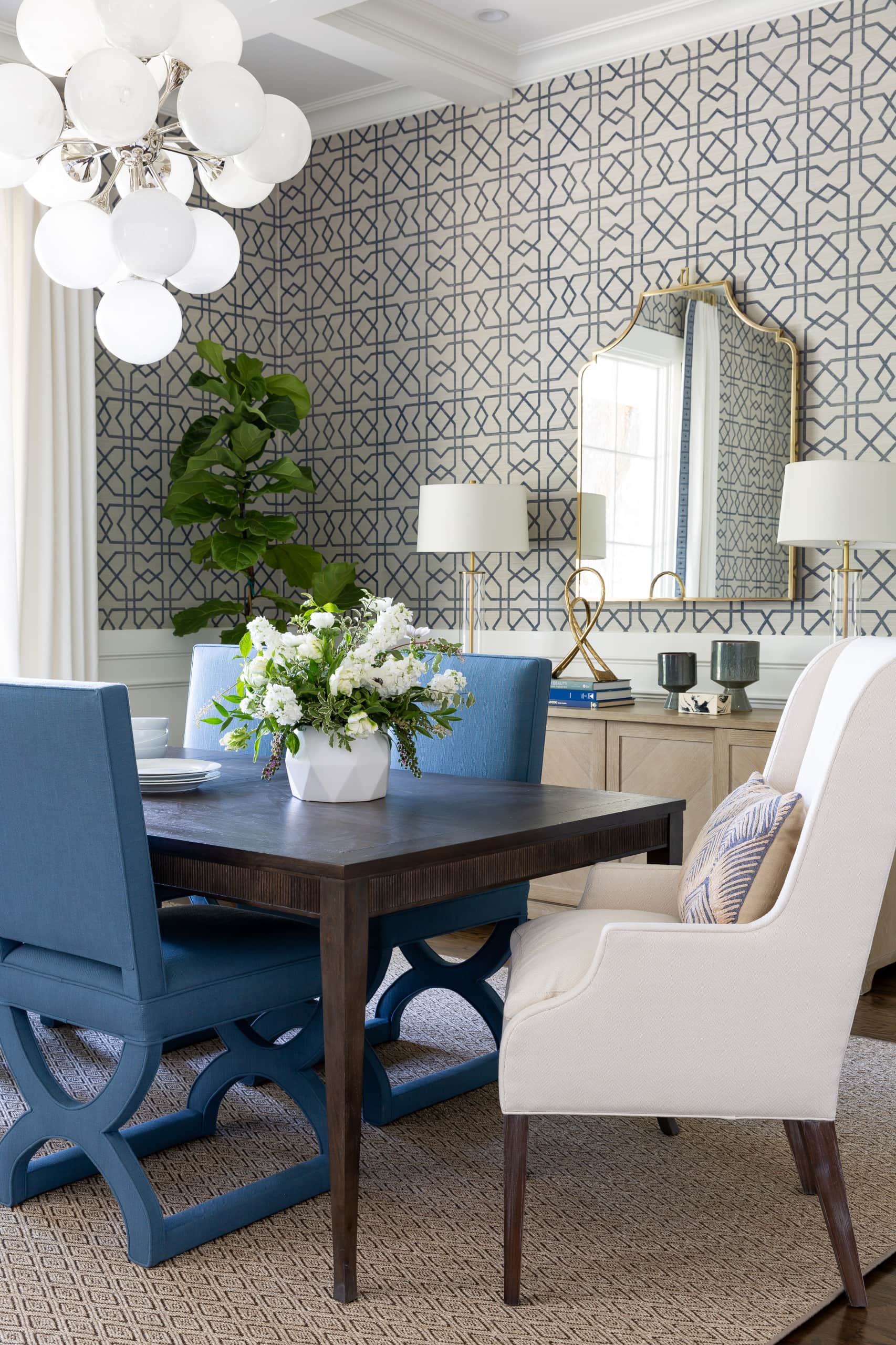 Dining room with a coastal style, featuring blue dining chairs and large dark wooden table. Home tour ideas.