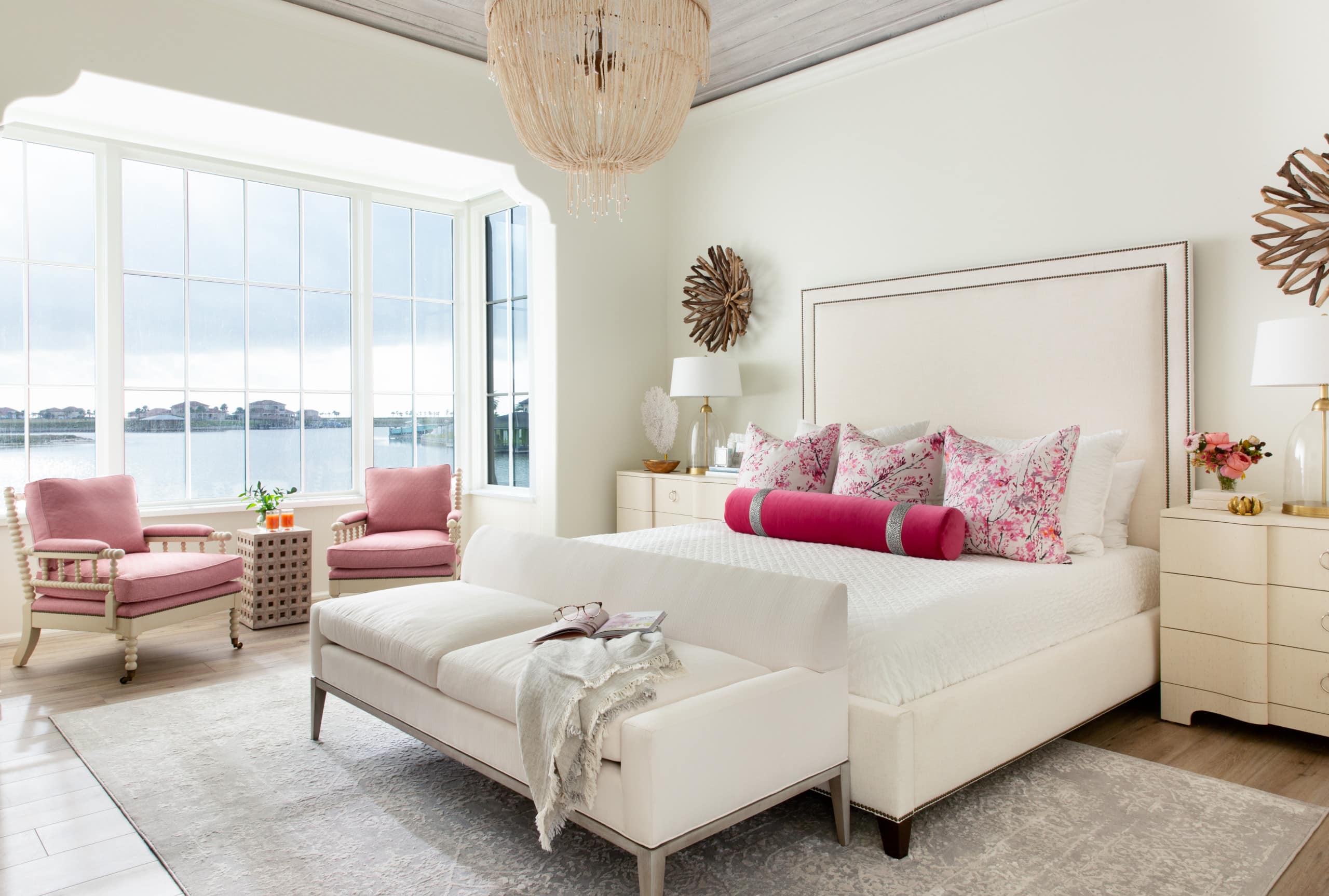 bedroom in coastal inspired decor featuring pink accents