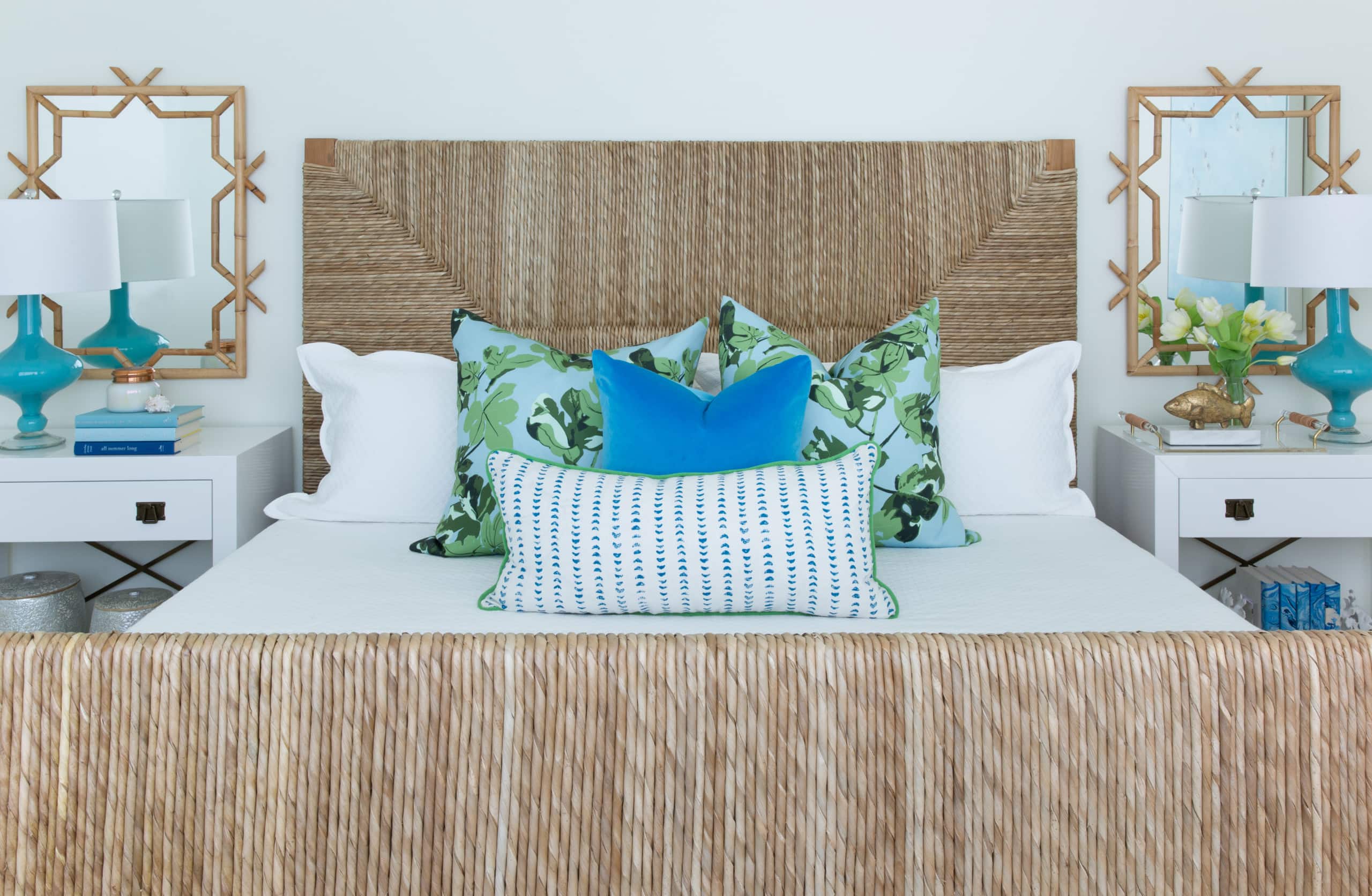 beach house with coastal style decor featuring teak bed and bamboo mirrors