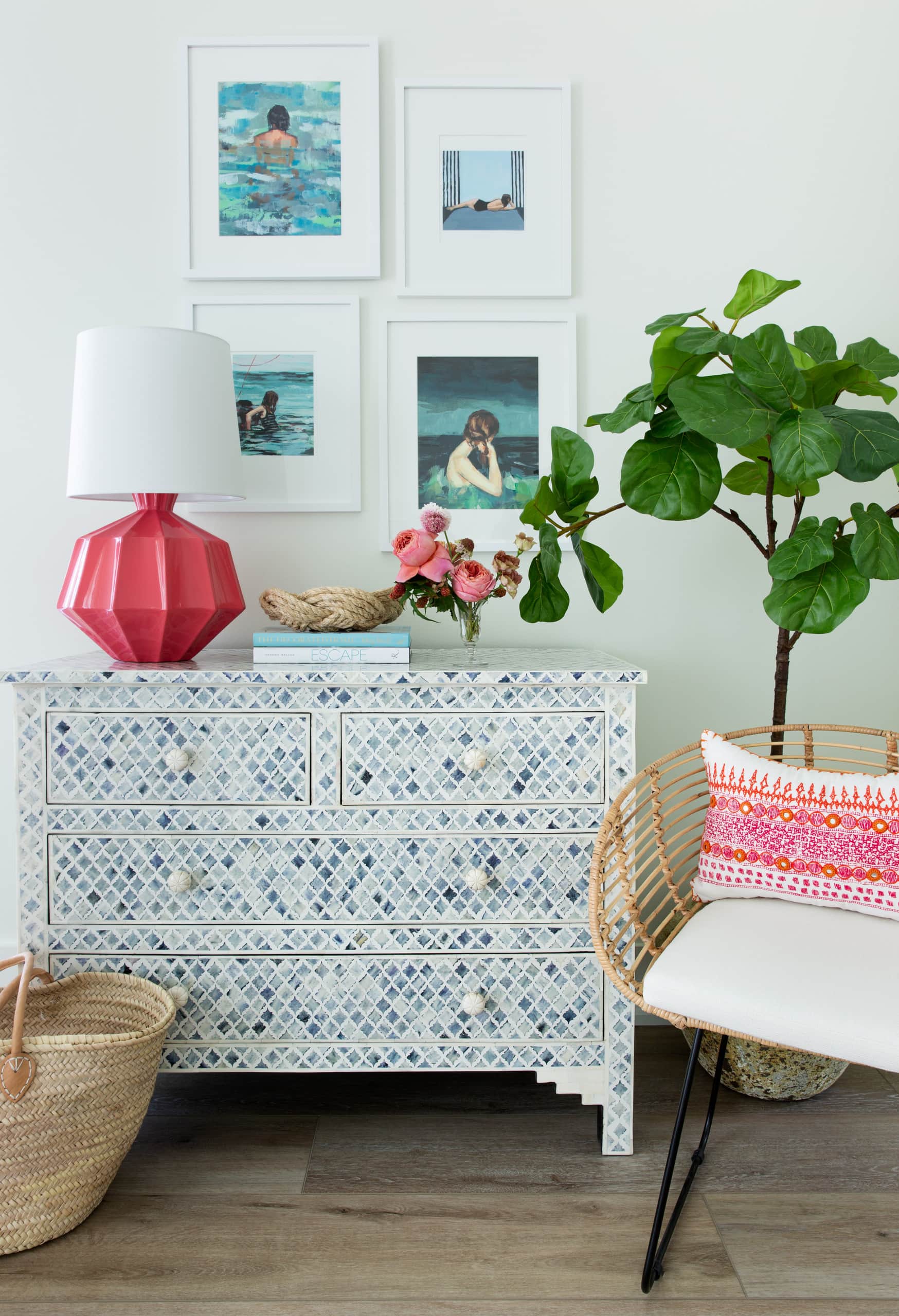 coastal inspired decor in beach house corner featuring bamboo armchair and console in blue