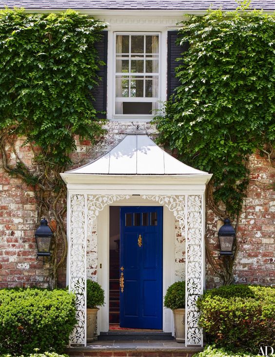 white portico featuring a blue front door