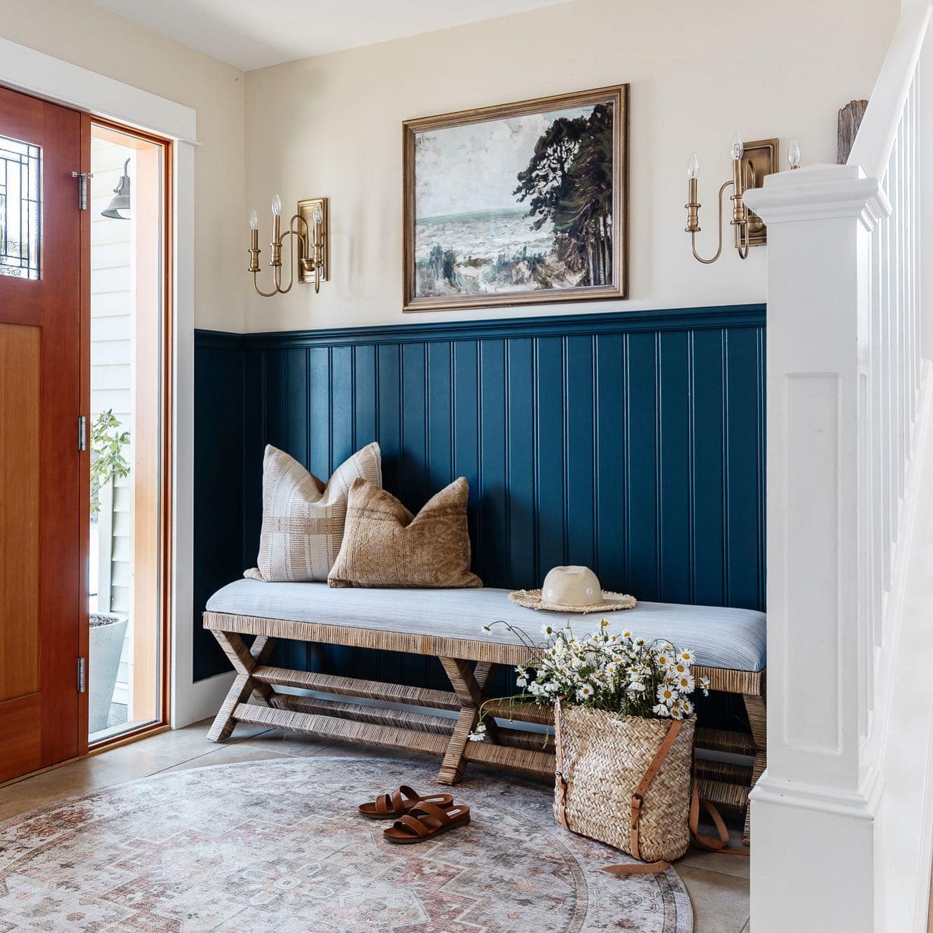 entryway idea featuring navy half wall and a rope bench in a contemporary home decor style
