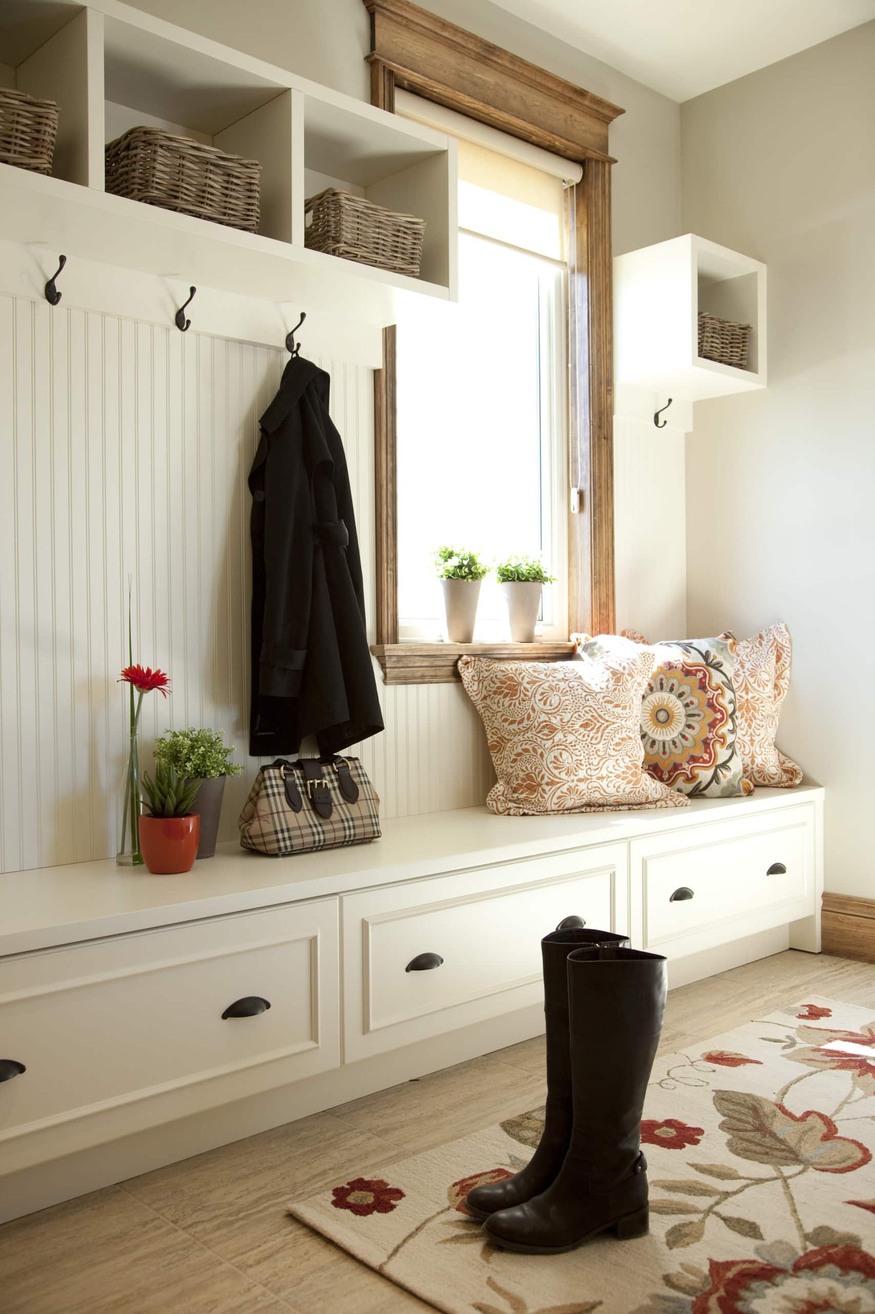 white shoe console, hooks, small stool and baskets in a entryway ideas