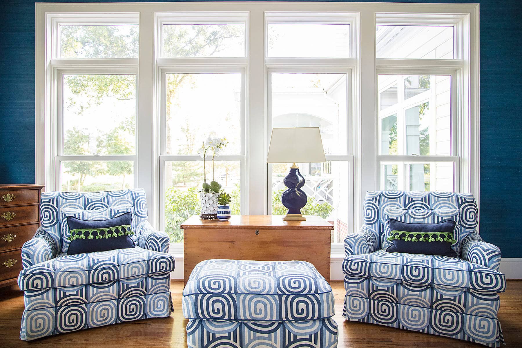 Home tour featuring living room in a traditional style featuring two armchairs and ottoman in geometric white and blue pattern