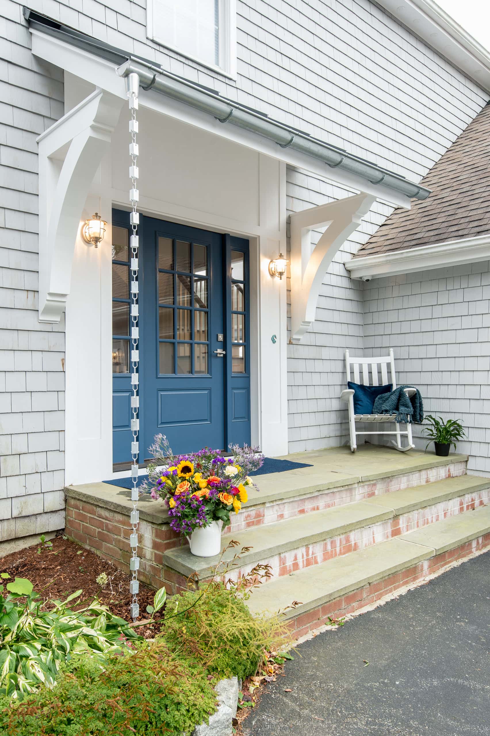 Coastal inspired portico featuring light blue front door