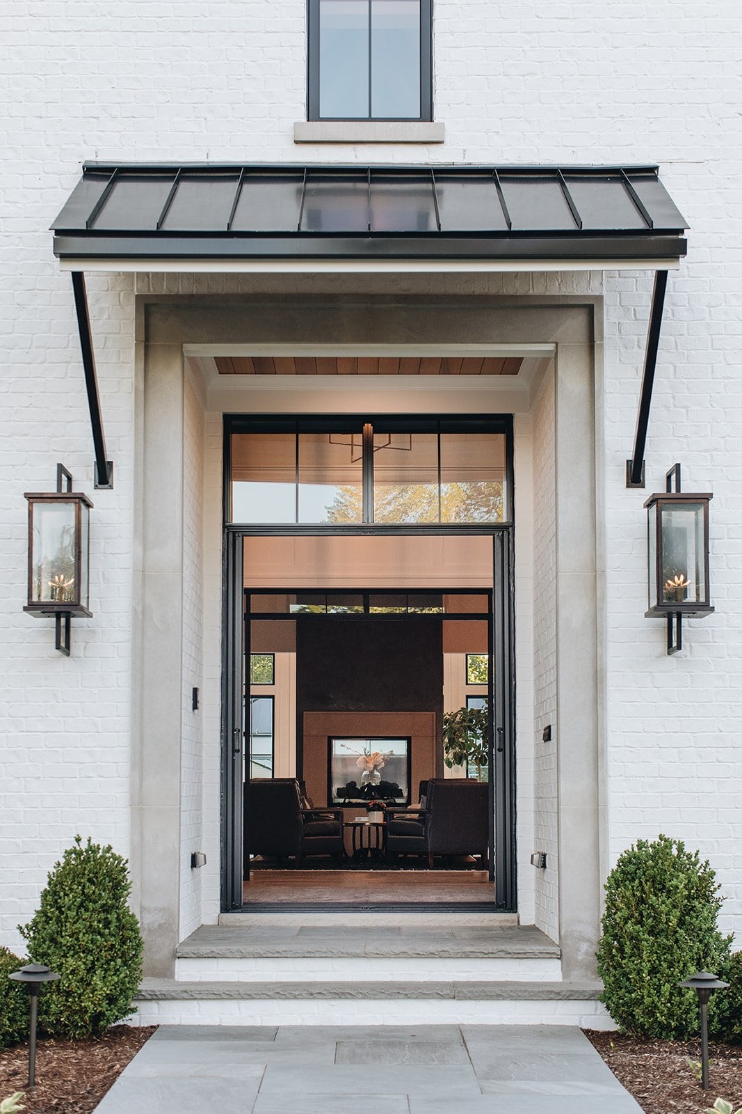Modern portico featuring a black and grid glass front door