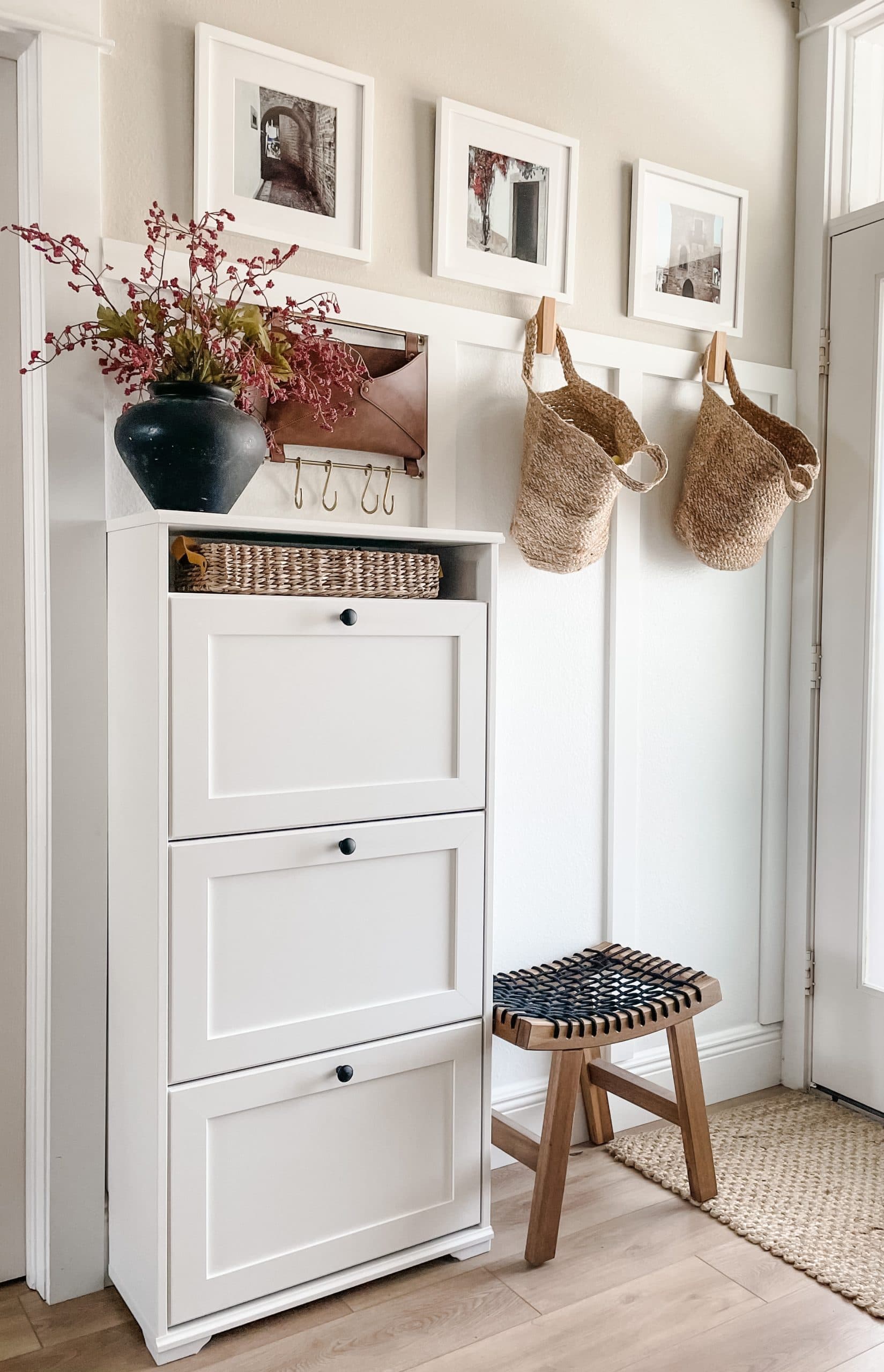 white shoe console, hooks, small stool and baskets in a entryway ideas