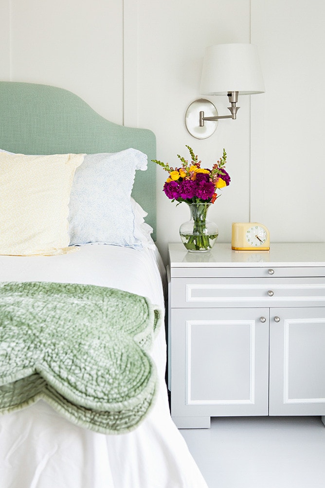 bedroom in coastal cottage featuring bed with mint colored quilt