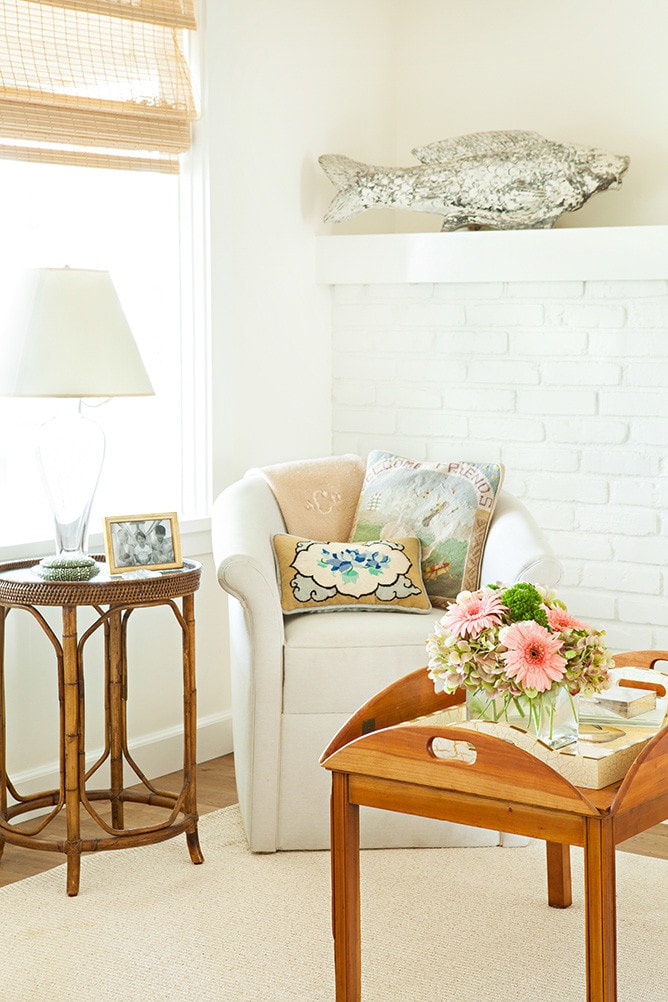 armchair with coastal inspired pillows in beach cottage home tour