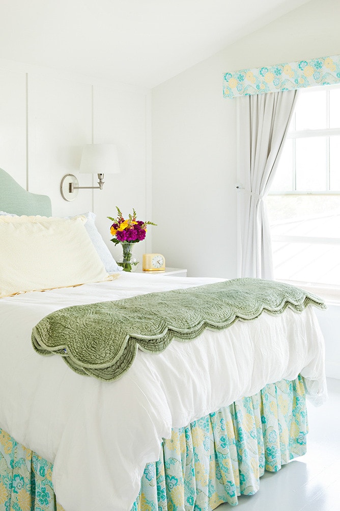 bedroom in coastal cottage featuring bed with mint colored quilt
