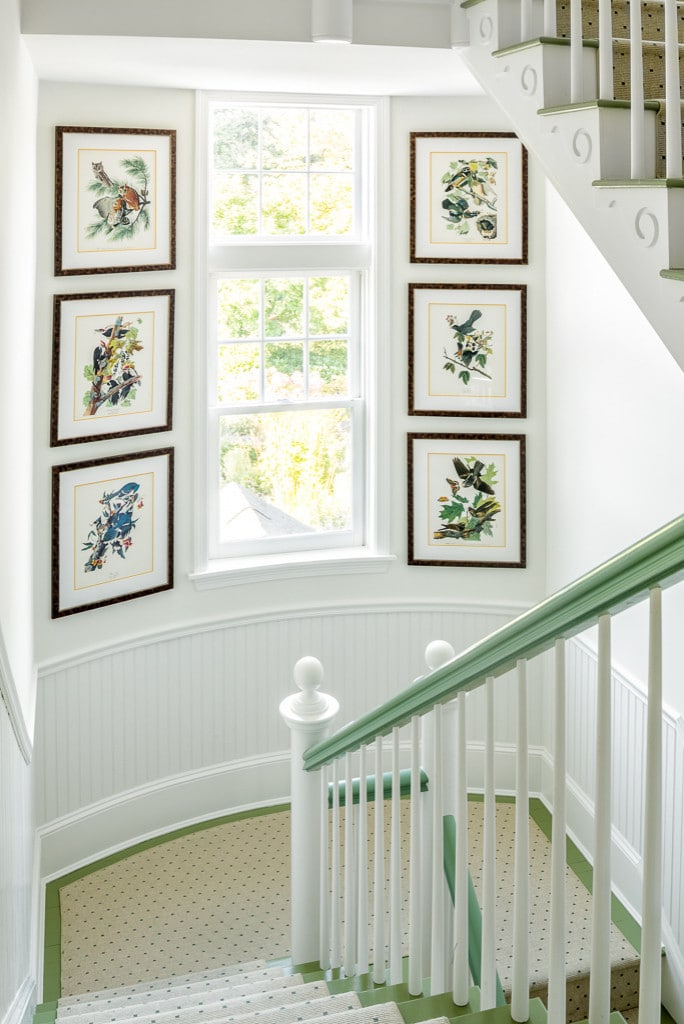 white staircase showcasing framed illustrations