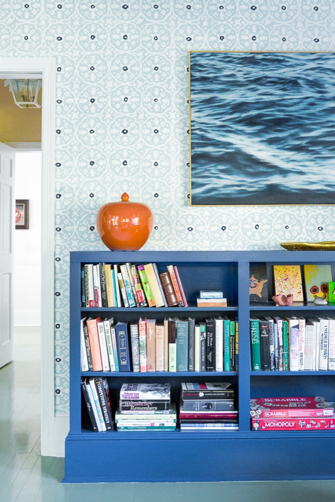 home tour beach style home featuring navy bookshelves with a orange decor element