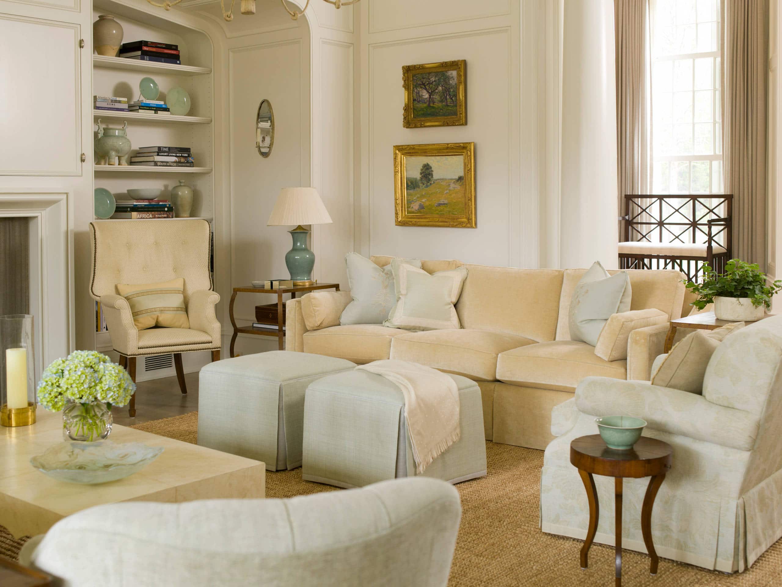 Charlotte house home tour featuring a elegant living room with light blue armchairs anc sofas