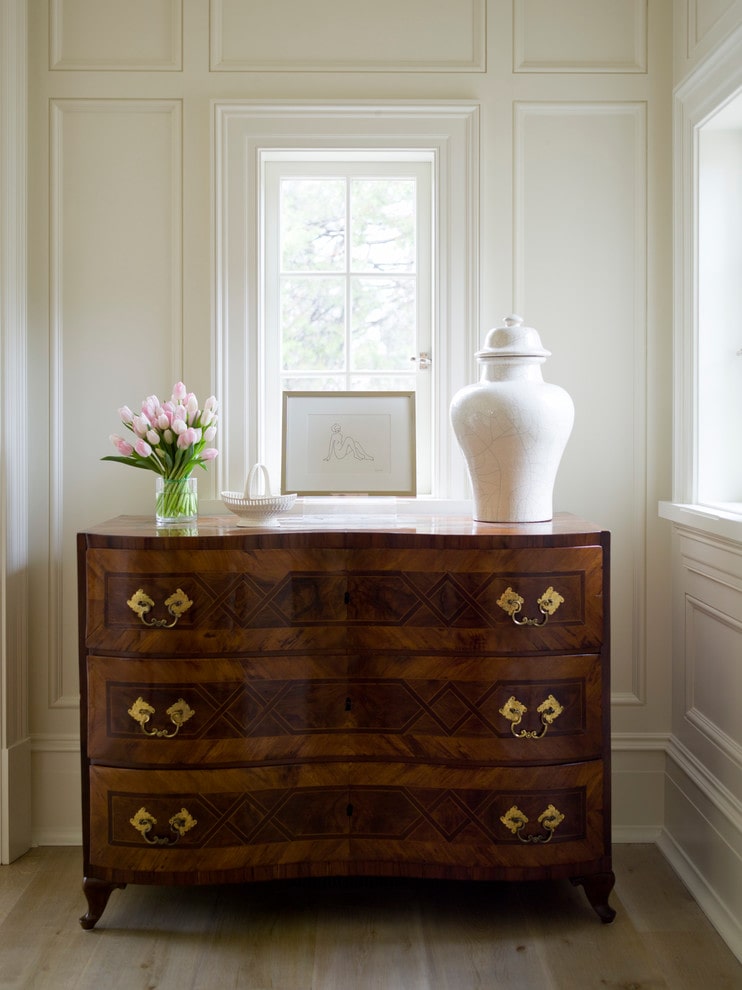 home tour space featuring chest drawers in a dark wood hue