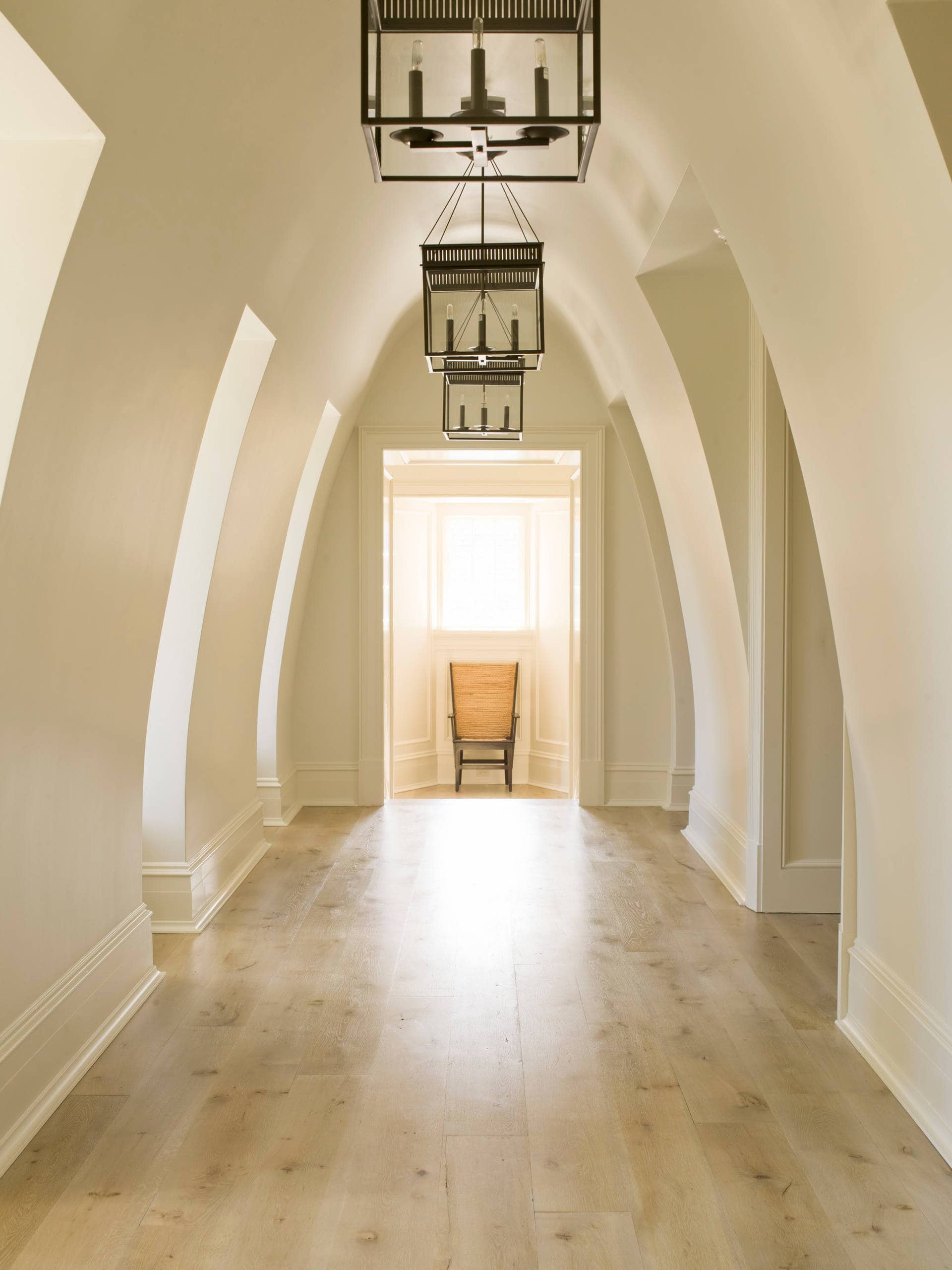 Traditional hallway in home tour featuring an arched structure