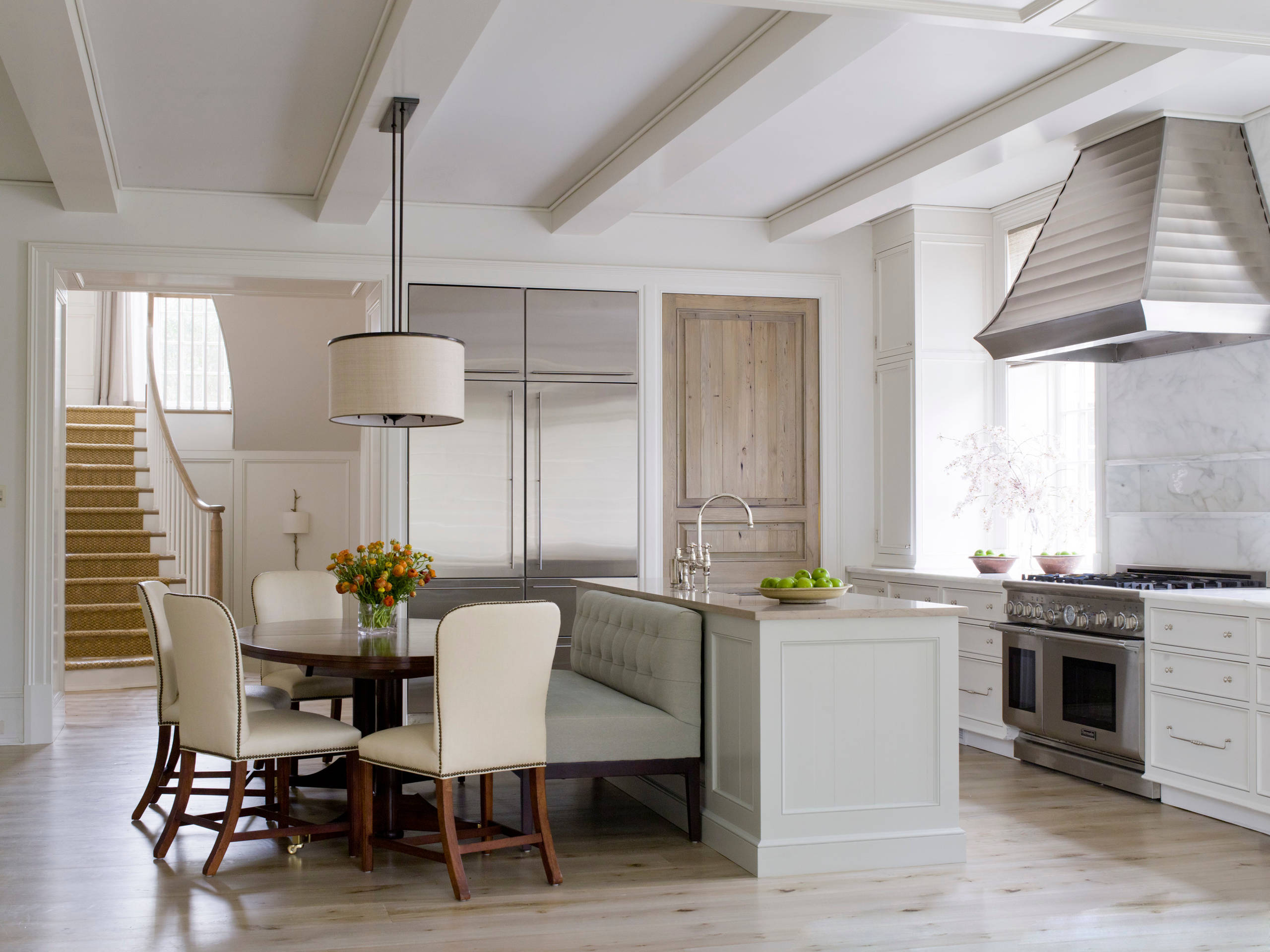 Modern and elegant kitchen featuring a kitchen island connected to a breakfast nook