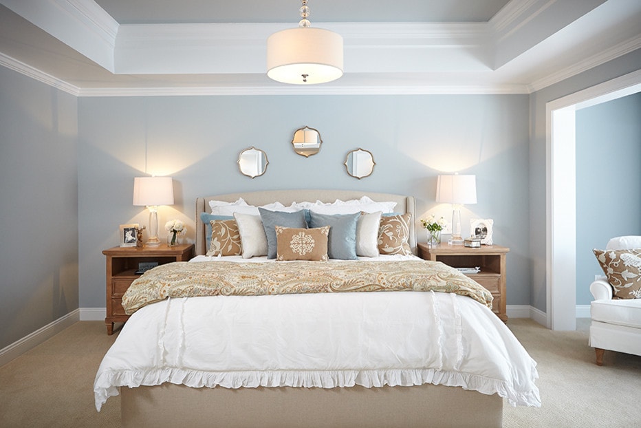 bedroom in light blue color scheme featured in traditional home tour 