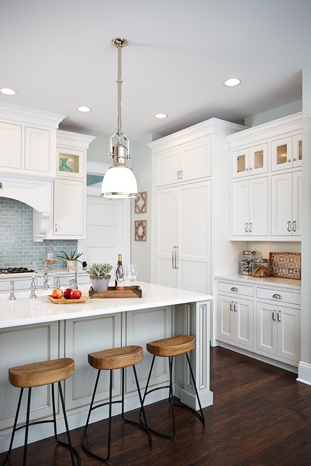 kitchen in traditional style home tour featuring white built in and light blue backsplash
