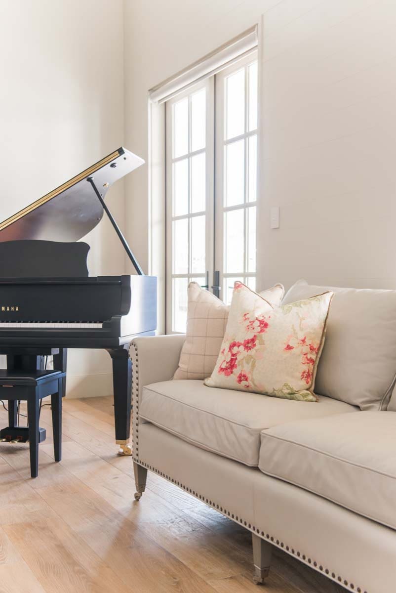 European style home tour living room featuring a piano