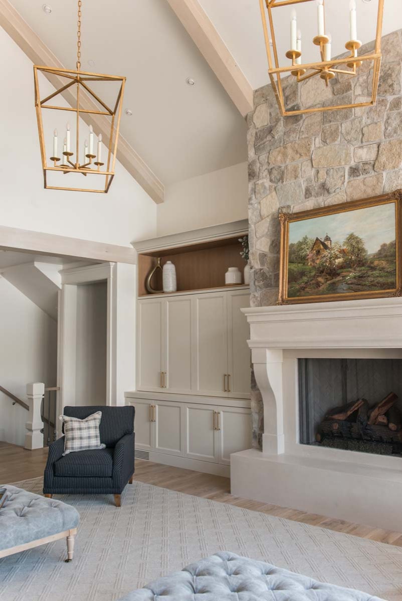 European style home tour living room featuring stone fireplace