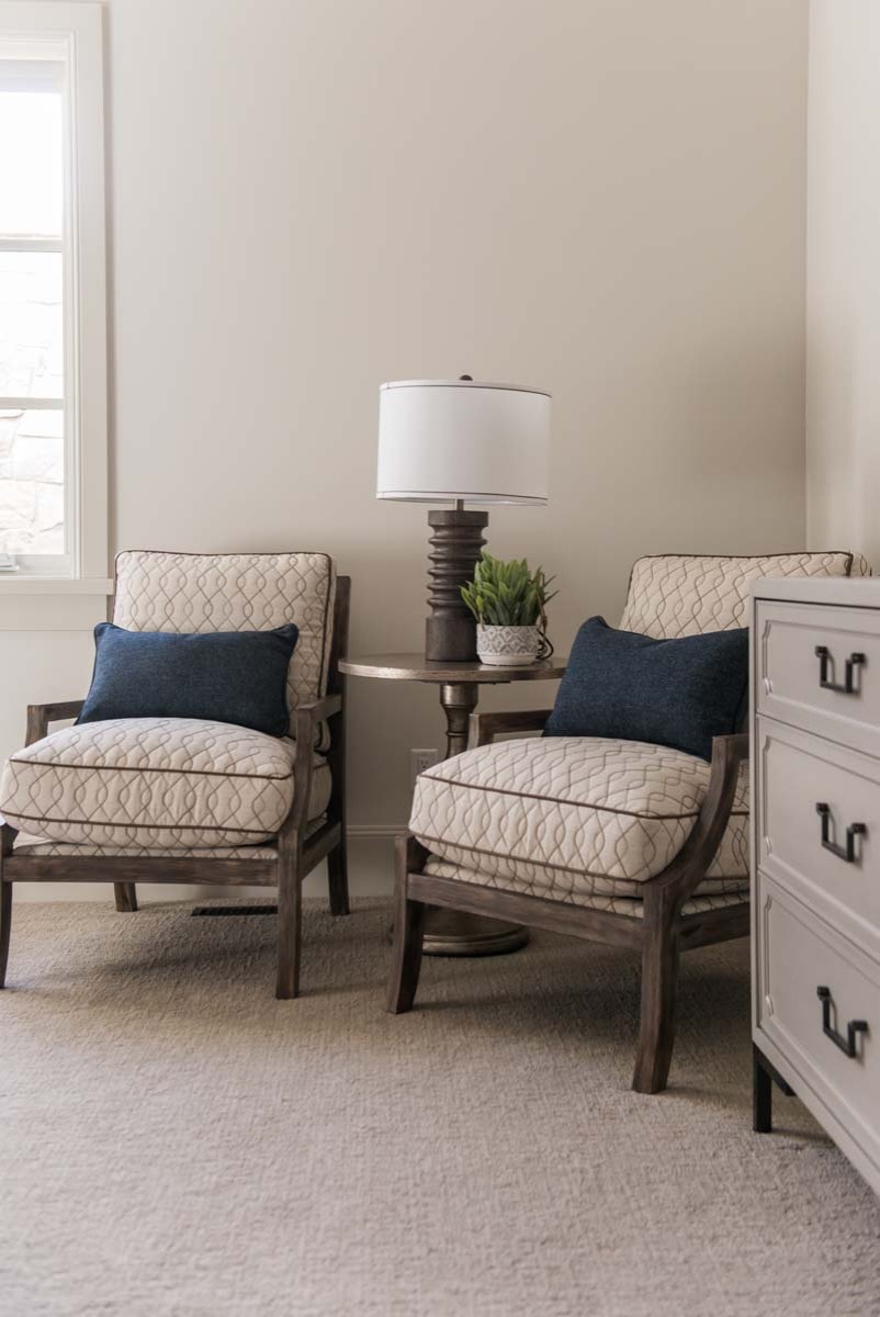 European style home tour bedroom featuring armchairs and table in a corner