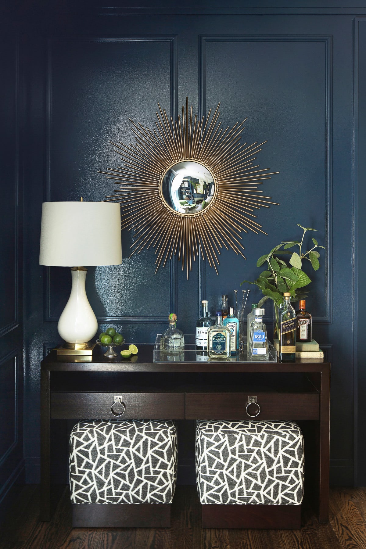 traditional living room featured in home tour showing glossy navy walls with a starburst mirror