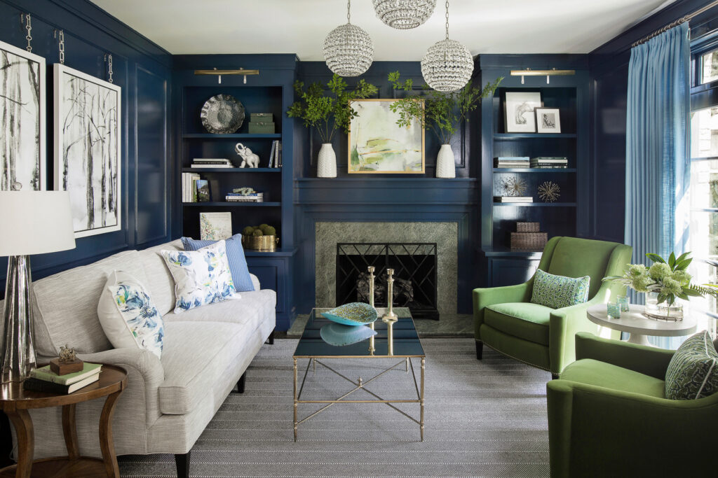 traditional living room featured in home tour showing glossy navy walls with green armchairs