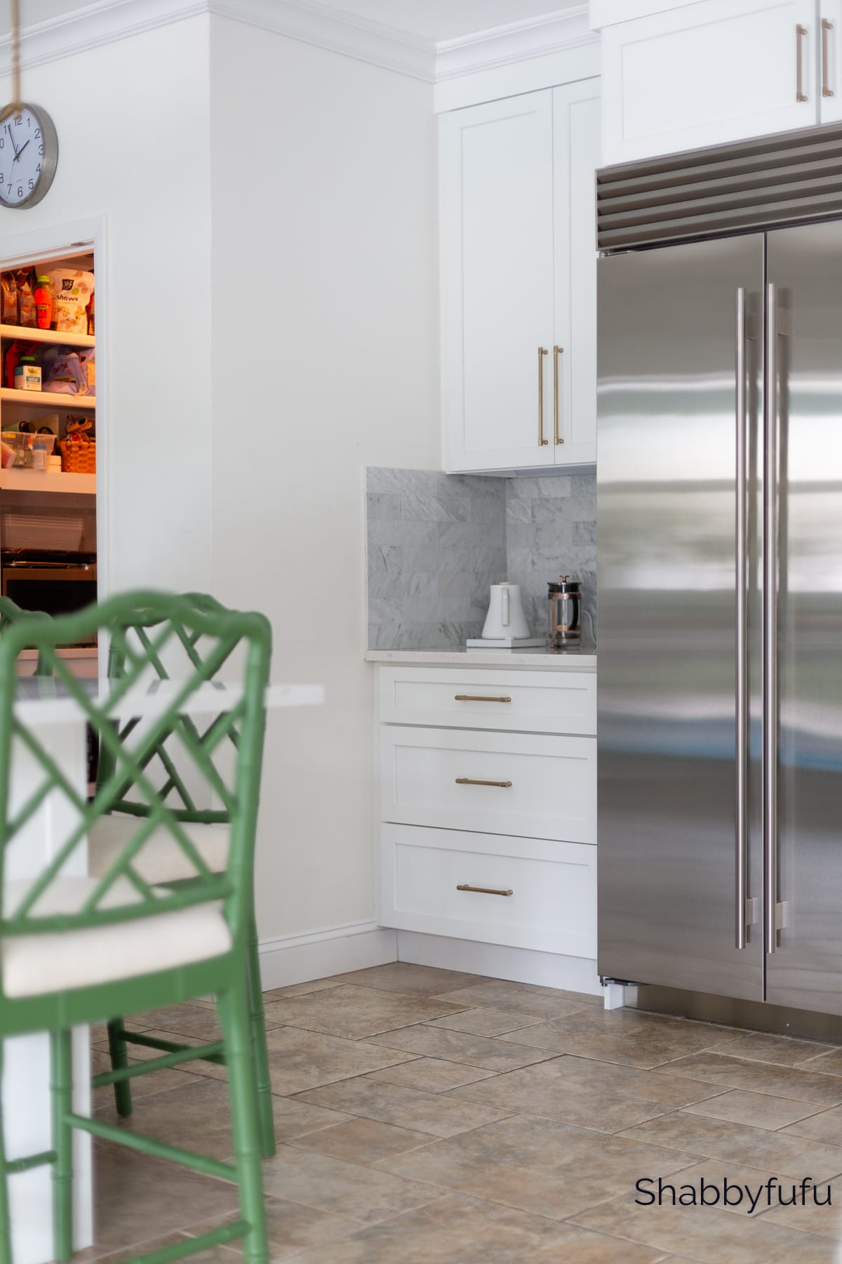 kitchen with subzero fridge and marble backsplash