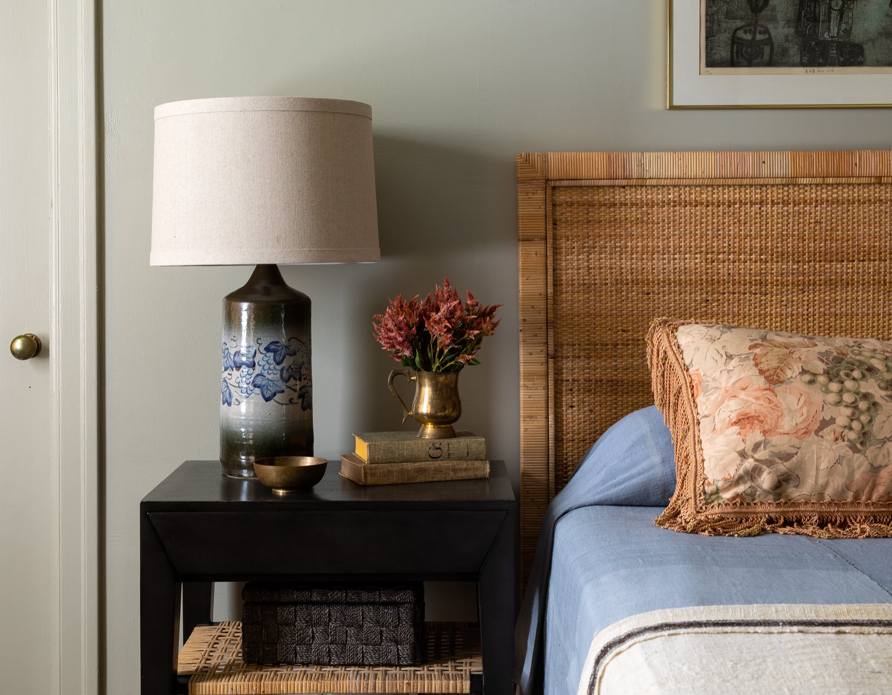home tour featuring a bedroom with a vintage-inspired interior design, showcasing a rattan bedframe