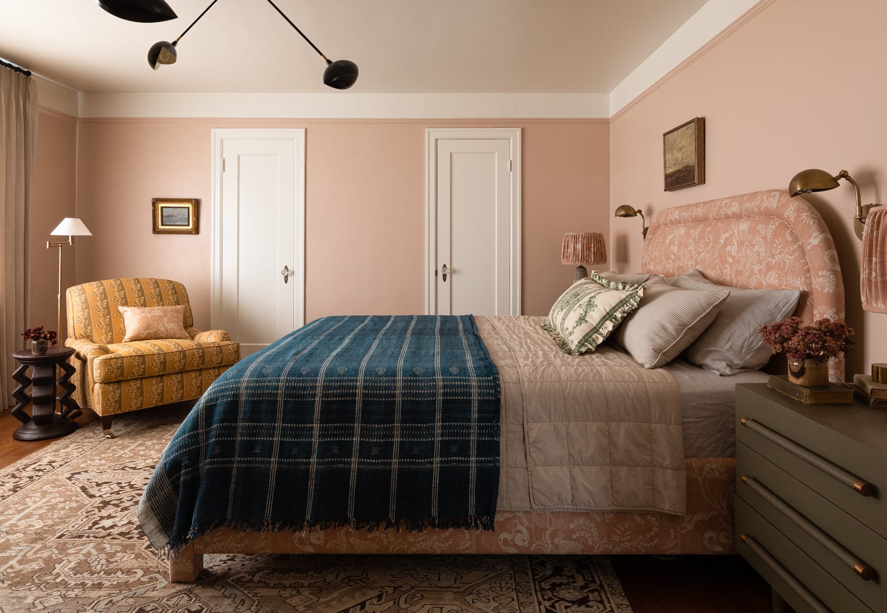 home tour featuring a vintage inspired cottage bedroom with salmon walls