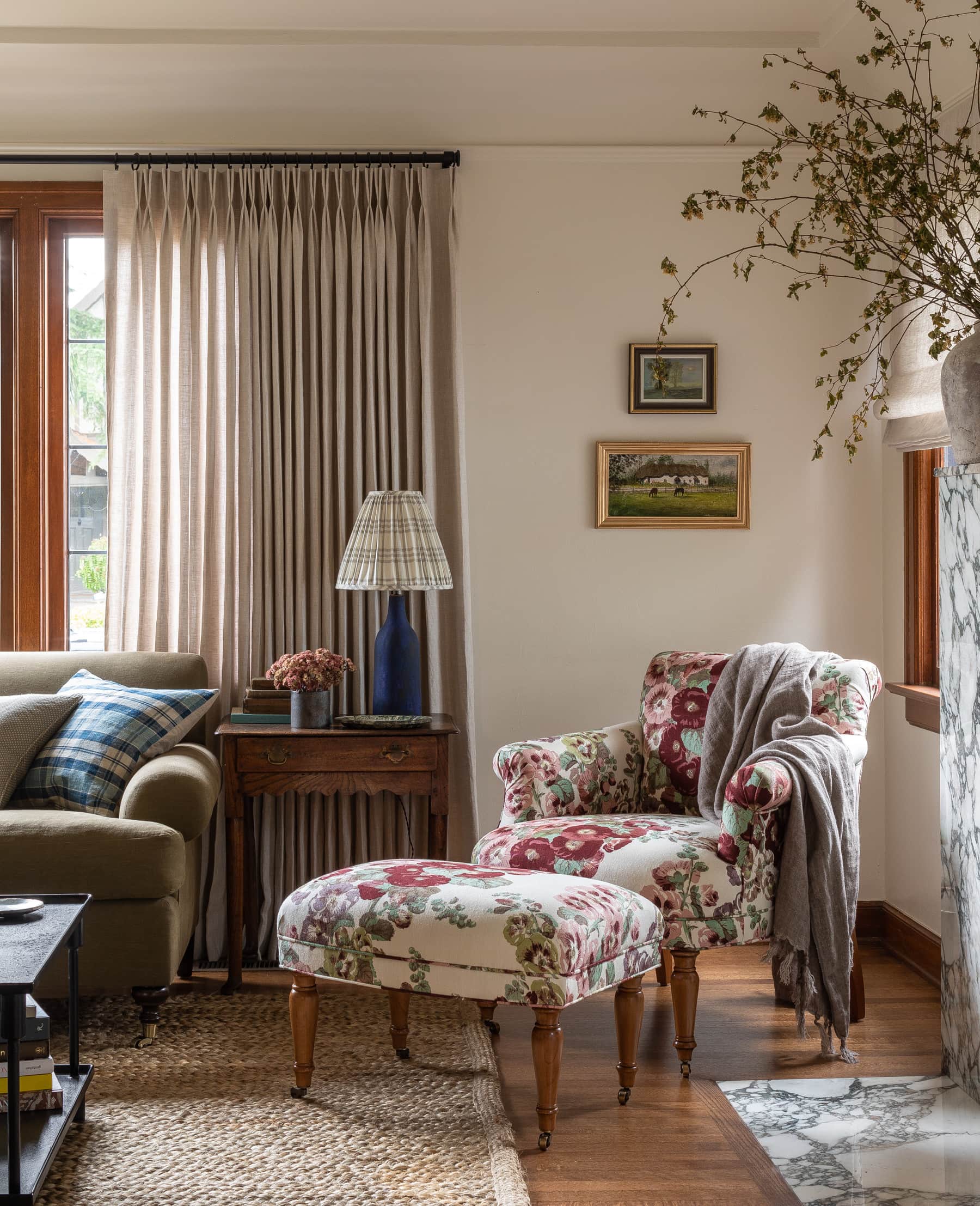 home tour featuring a dining room with showcasing a floral patterned armchair in a vintage cottage decor
