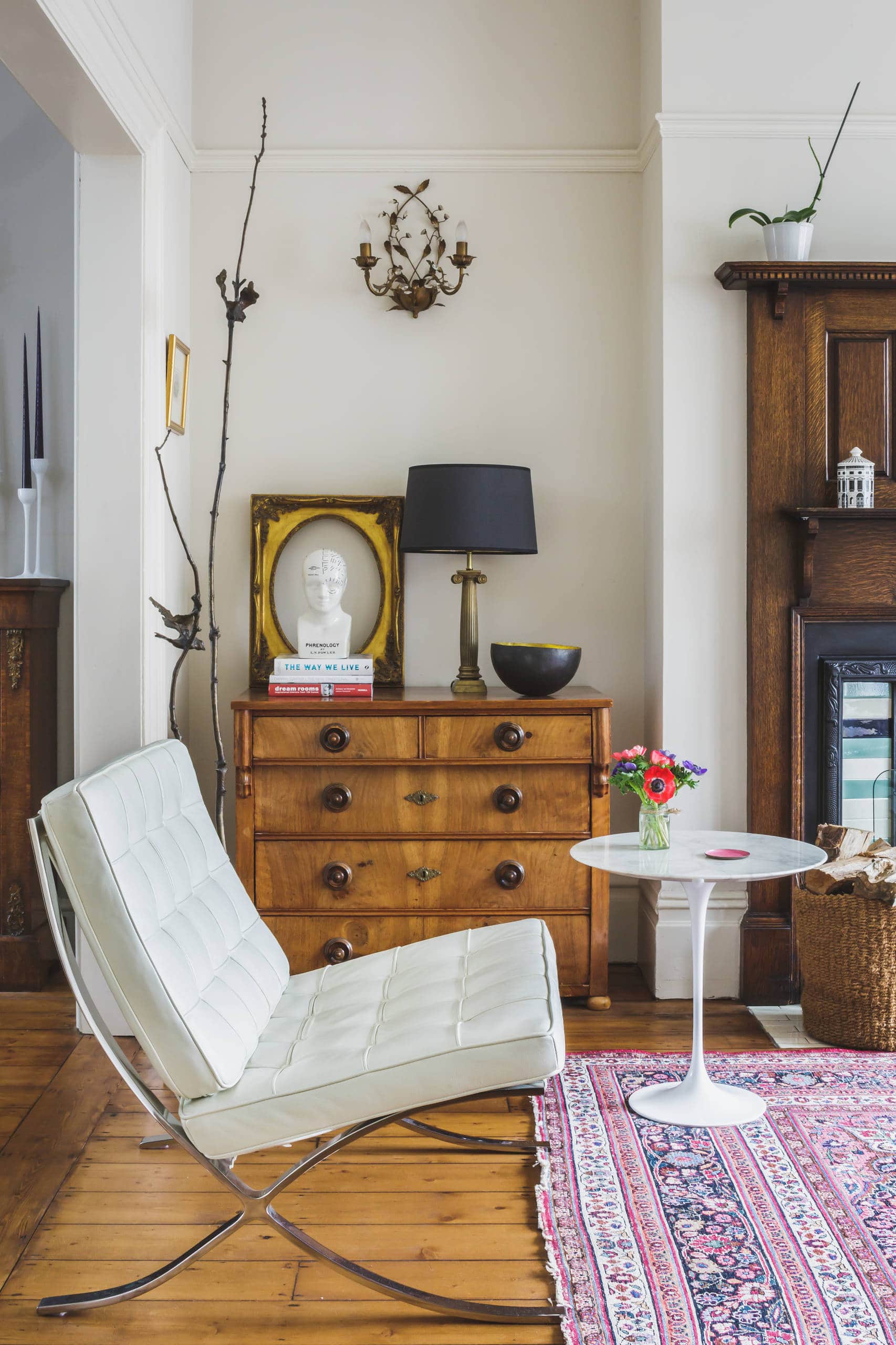 Mixing vintage and antiques in modern spaces idea featuring an antique drawer chest in contemporary living room