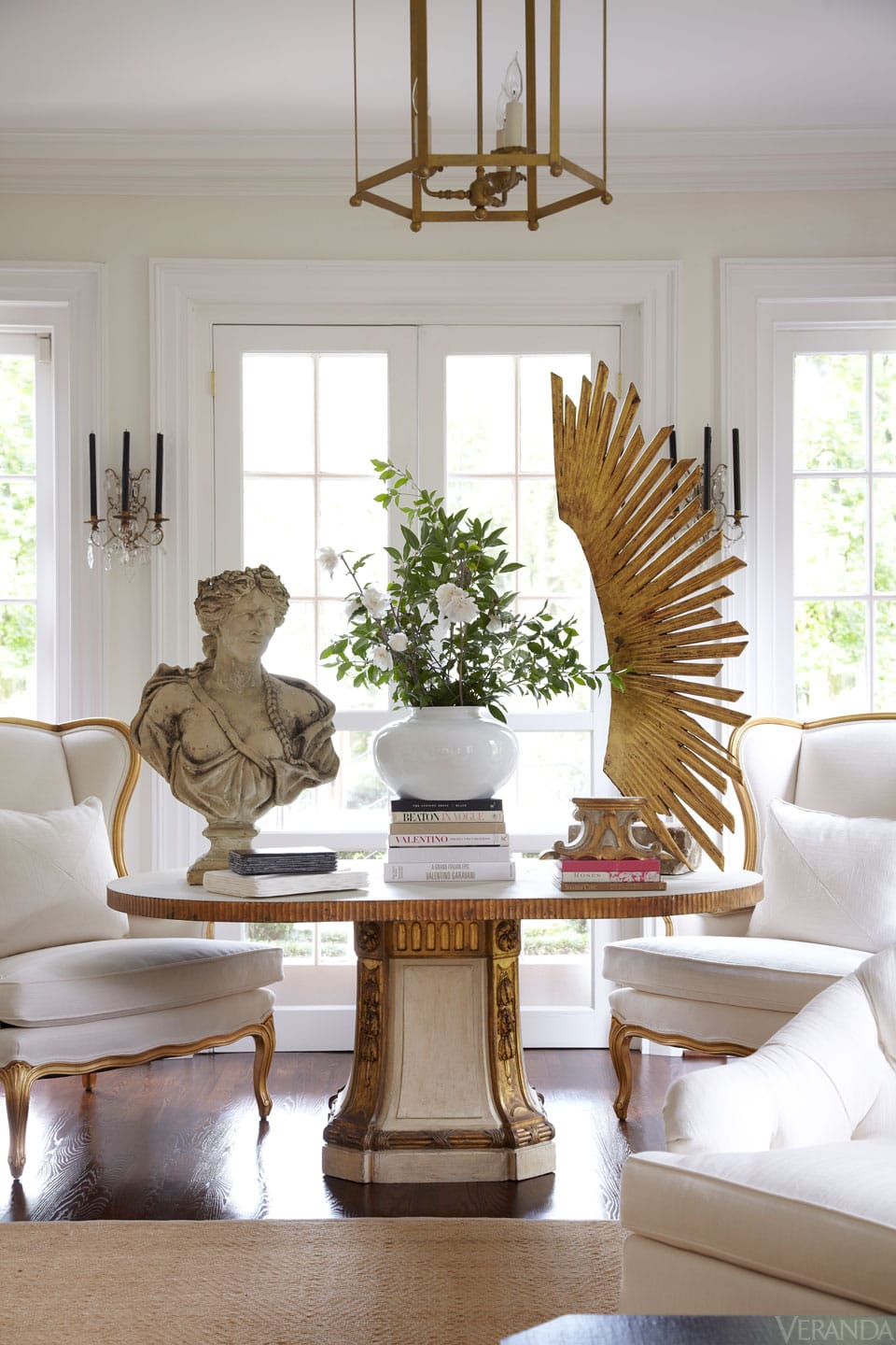 Mixing vintage and antiques in modern spaces idea featuring a round table with an antique buste
