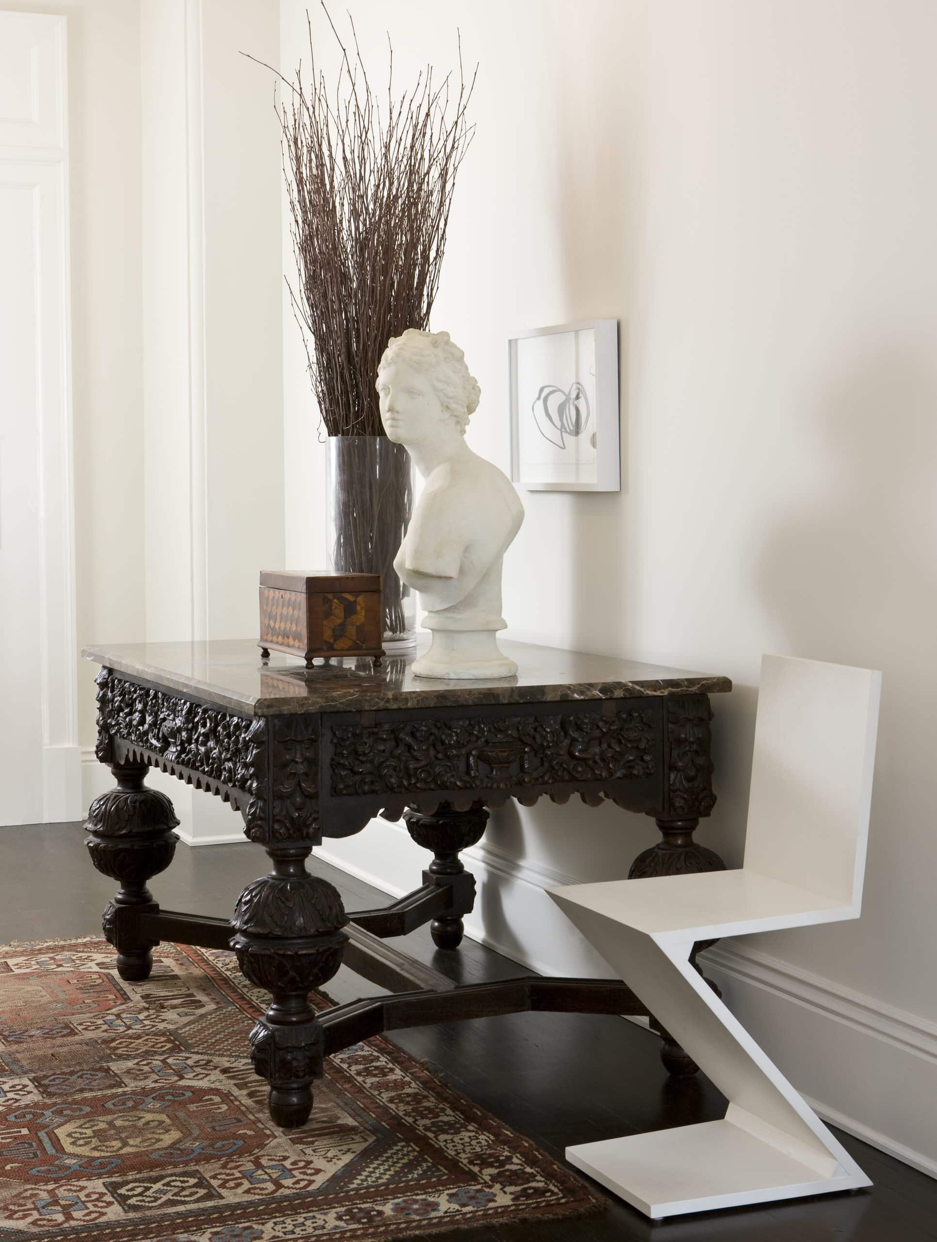 Mixing vintage and antiques in modern spaces idea featuring a antique console table in an entryway