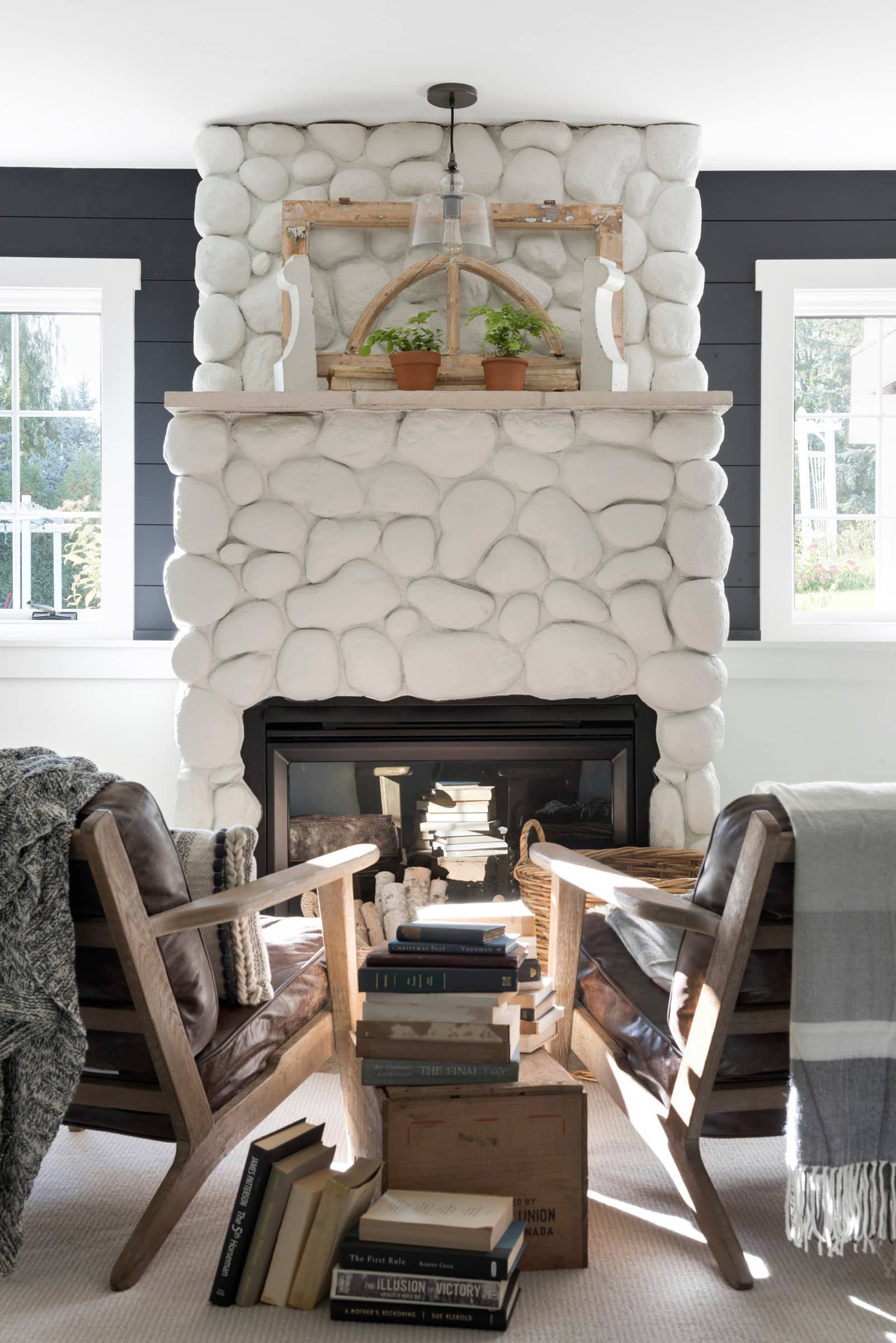 basement in farmhouse style featuring stone fireplace painted white featured in home tour