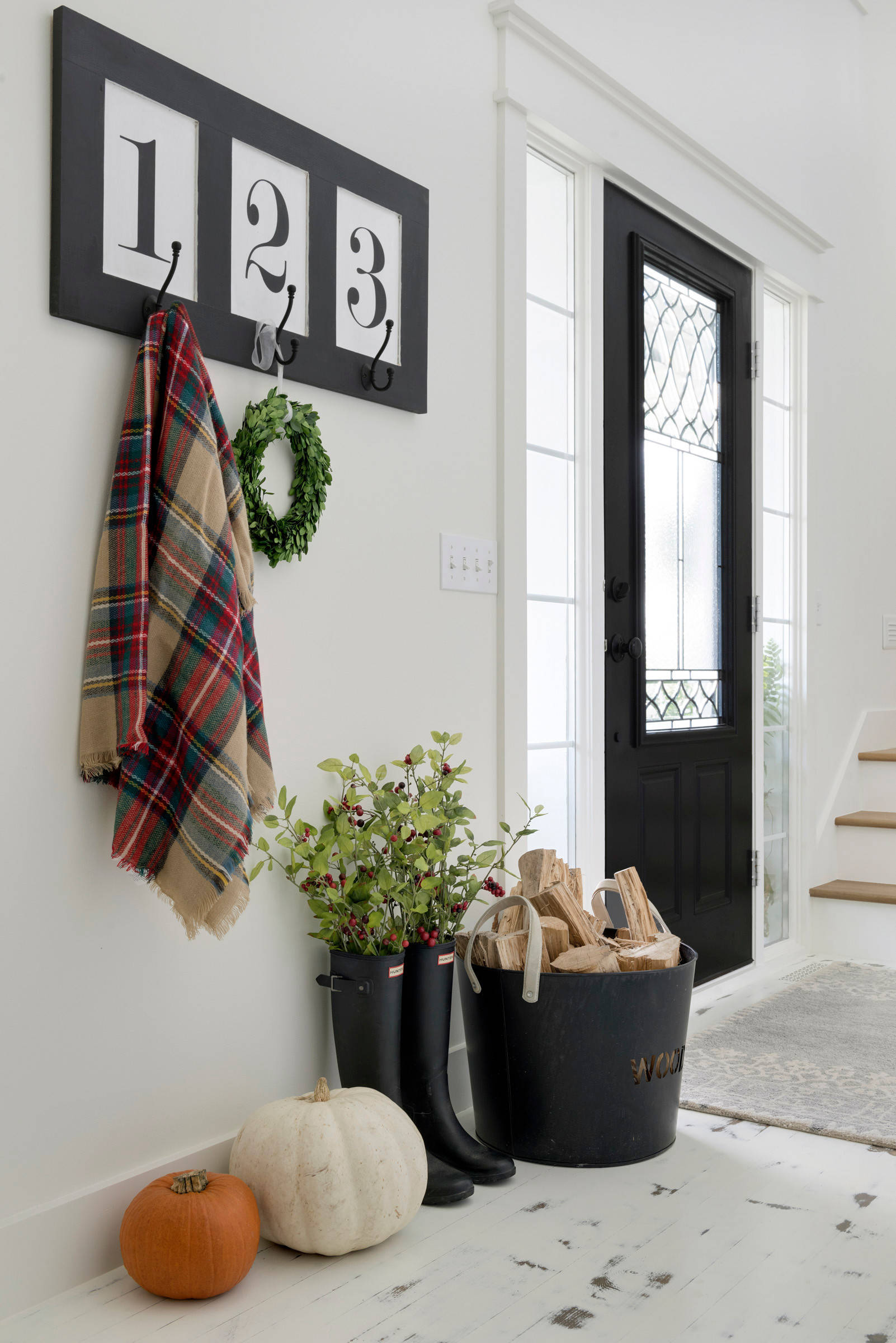 entryway in farmhouse style featuring a fall arrangement featured in home tour