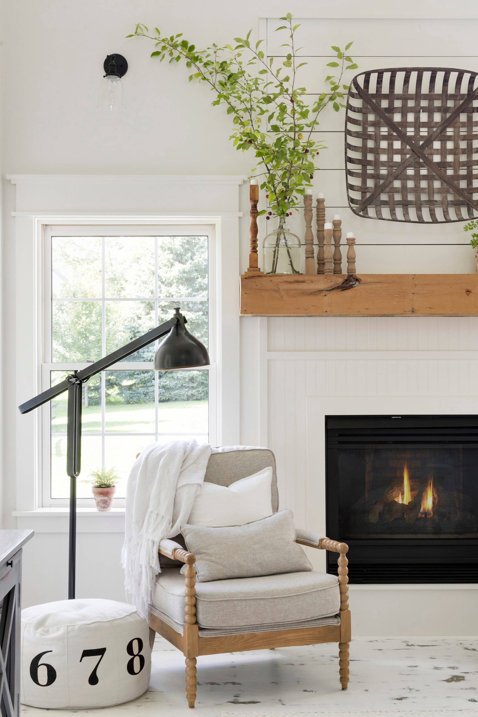 living room in farmhouse style featuring a fireplace featured in home tour
