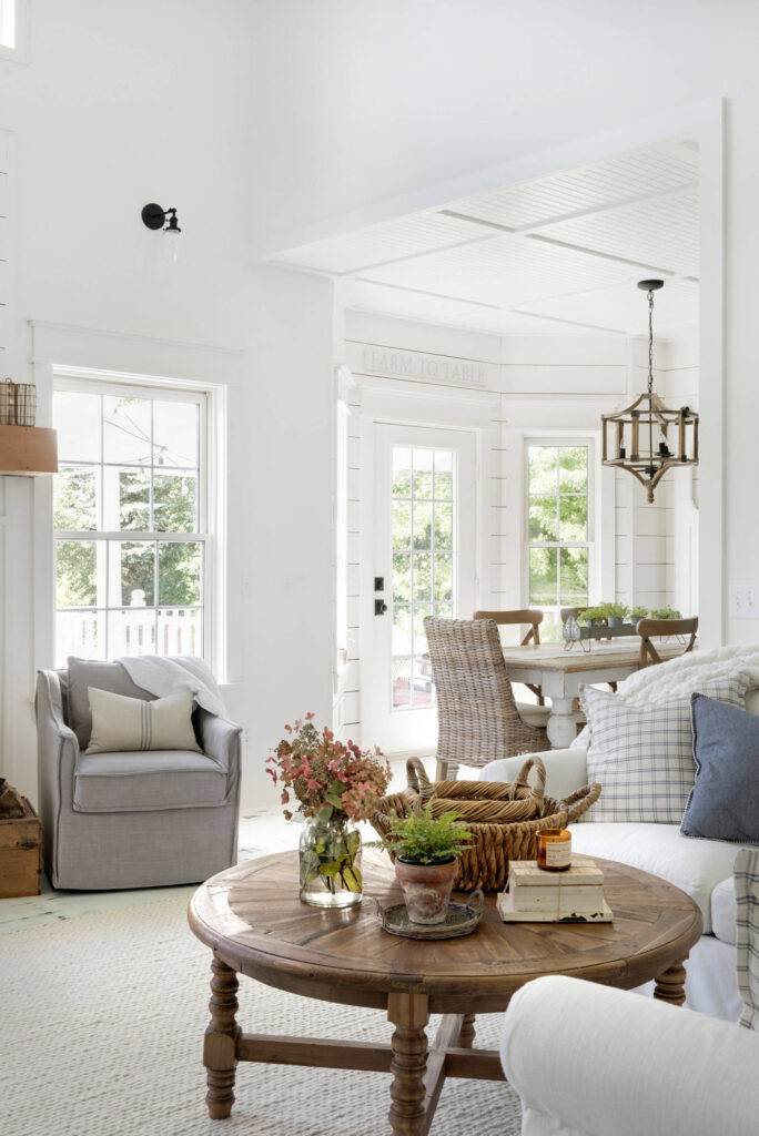 living room in farmhouse style featuring a white background, wood accents, and farmhouse decor featured in home tour