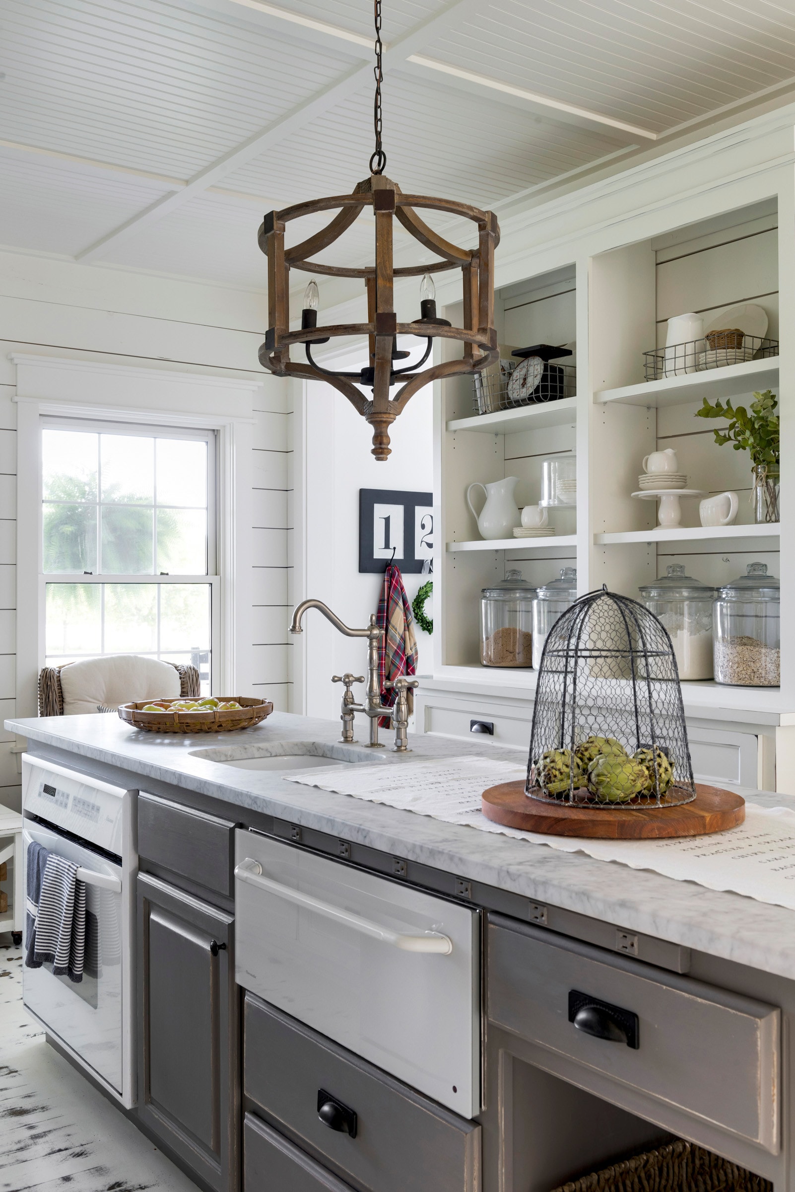 kitchen in farmhouse style featuring a distressed white cabinets featured in home tour