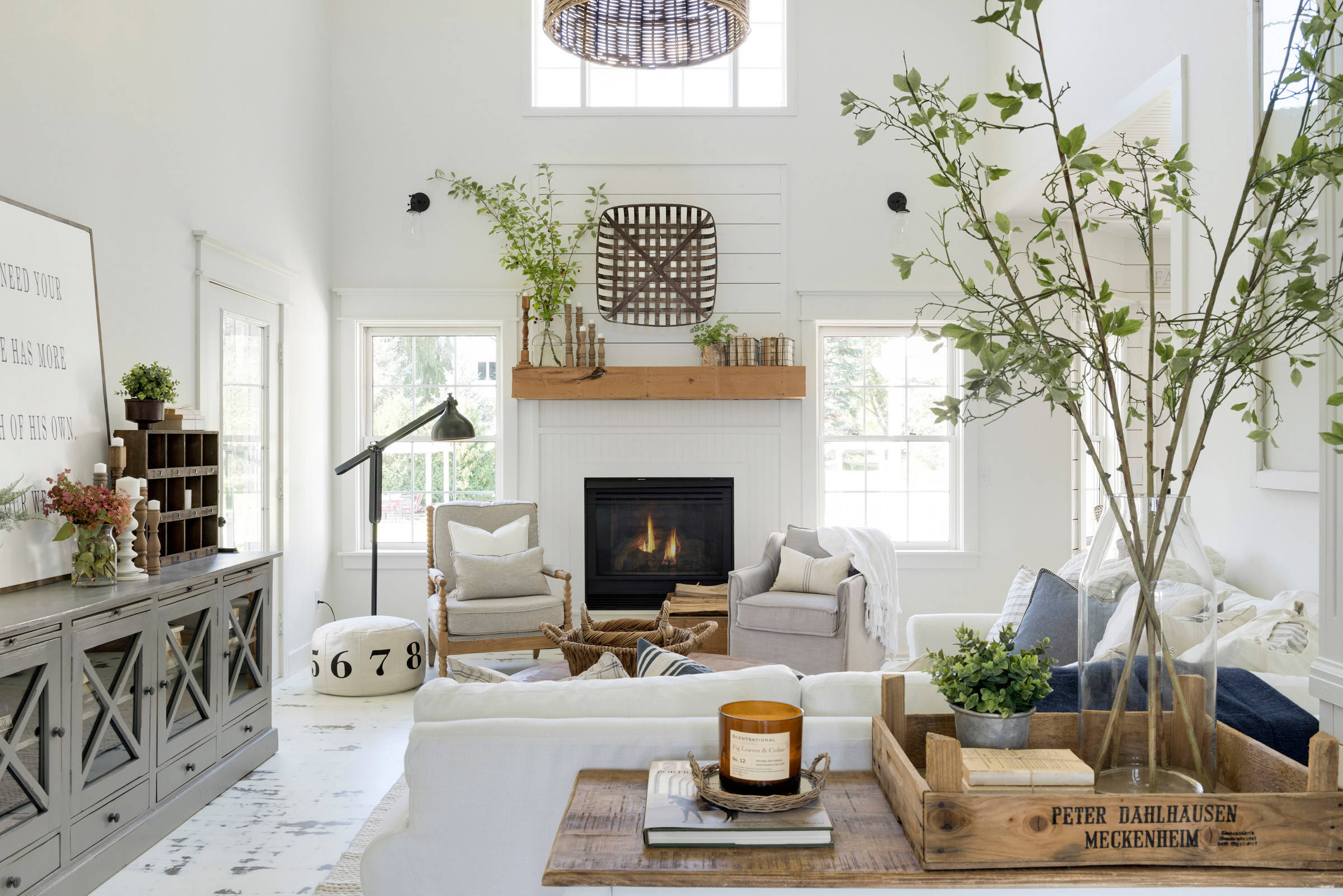 living room in farmhouse style featuring a white background, wood accents, and farmhouse decor featured in home tour