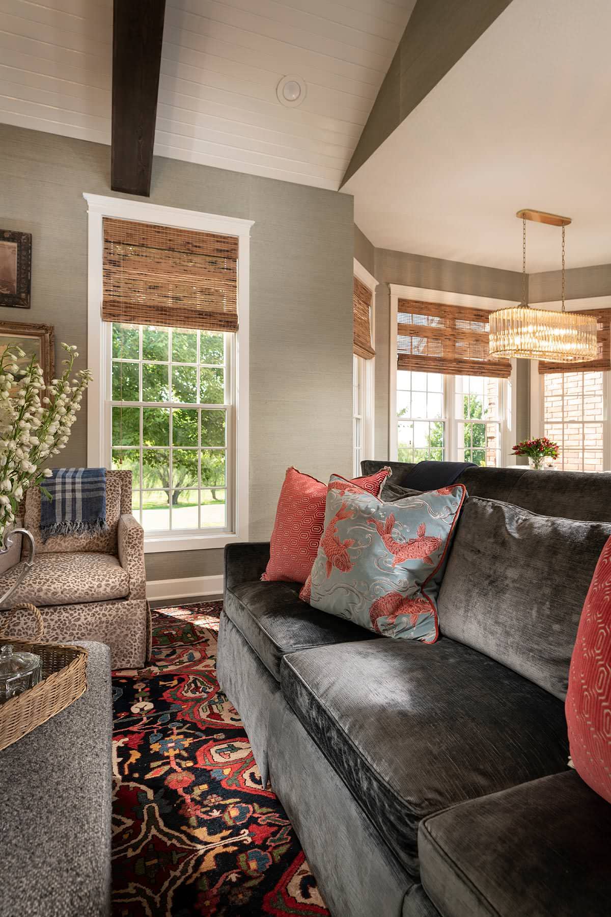 living room from home tour featured in a english cottage styled home displaying a dark gray sofa
