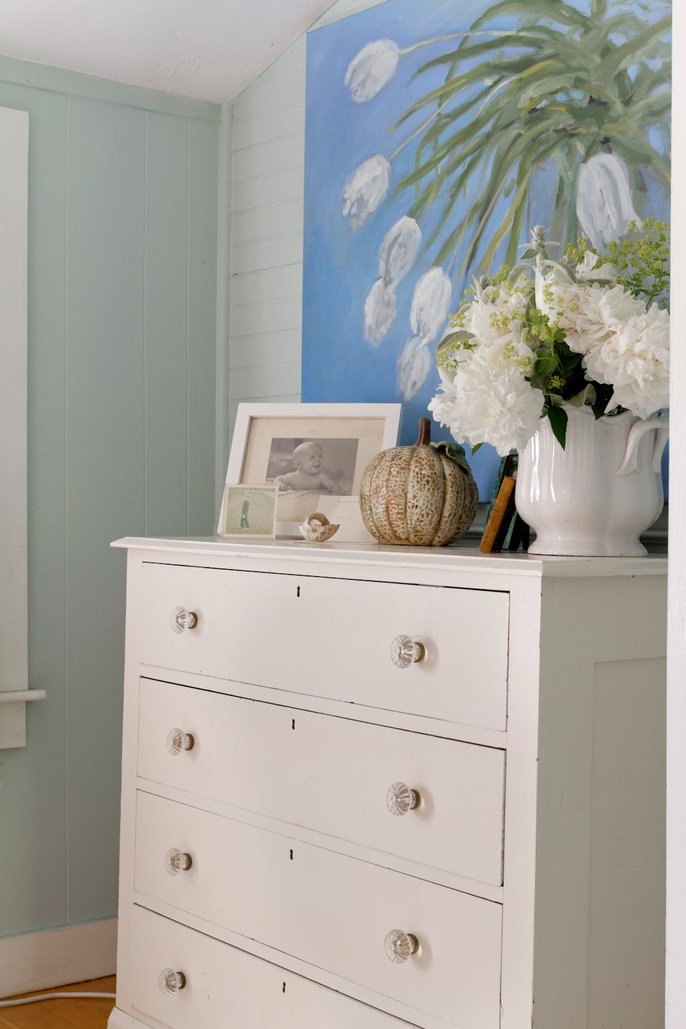 Small cottage bedroom featured in home tour, with light blue walls and coastal, traditional and romantic decor.