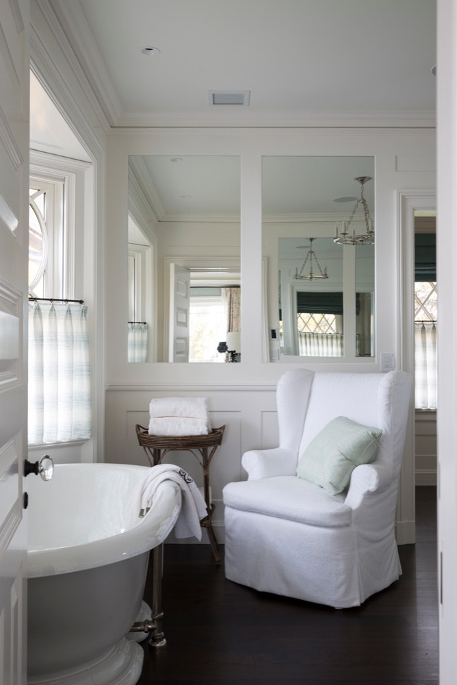 Traditional shingle style home tour featuring a bathroom with white armchair
