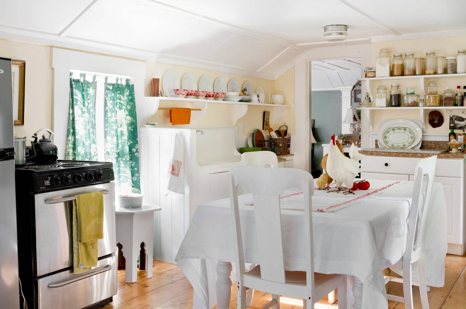 Whimsical and retro rustic style in a cottage kitchen featured in home tour, pale yellow walls.