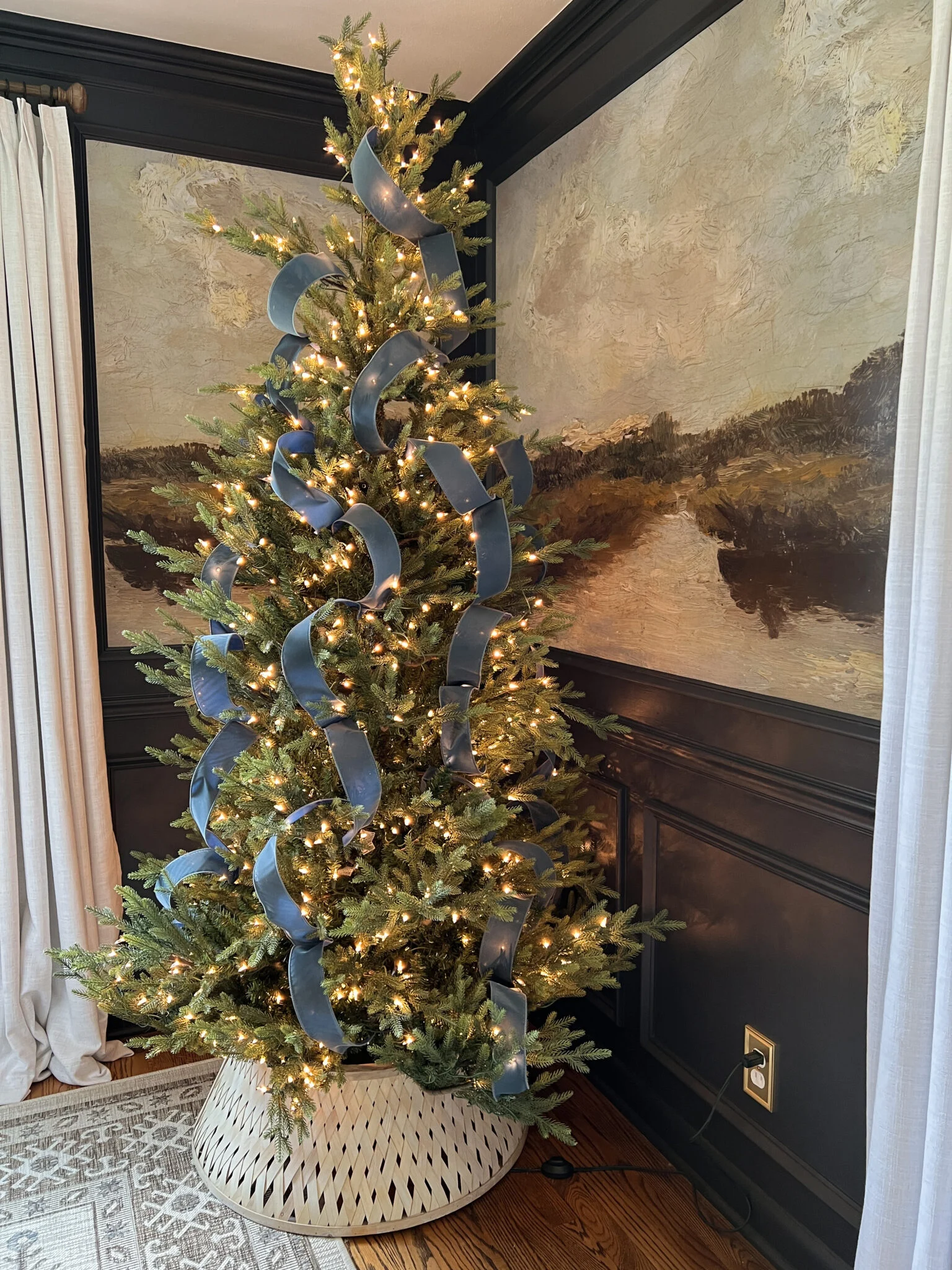 Traditional style Christmas tree idea featuring large velvet blue ribbons