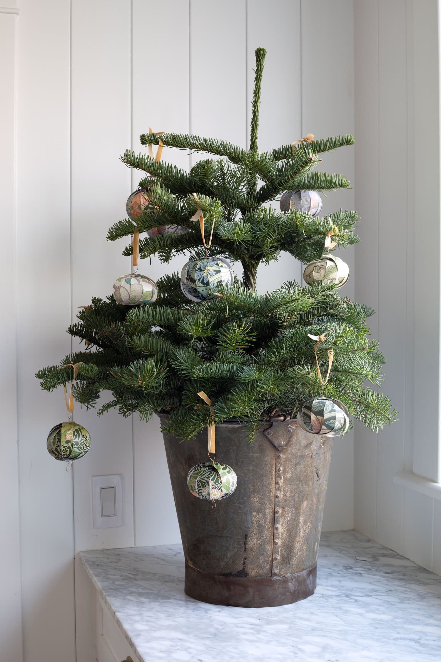 Christmas tree idea featuring a small tree inside a wooden basket