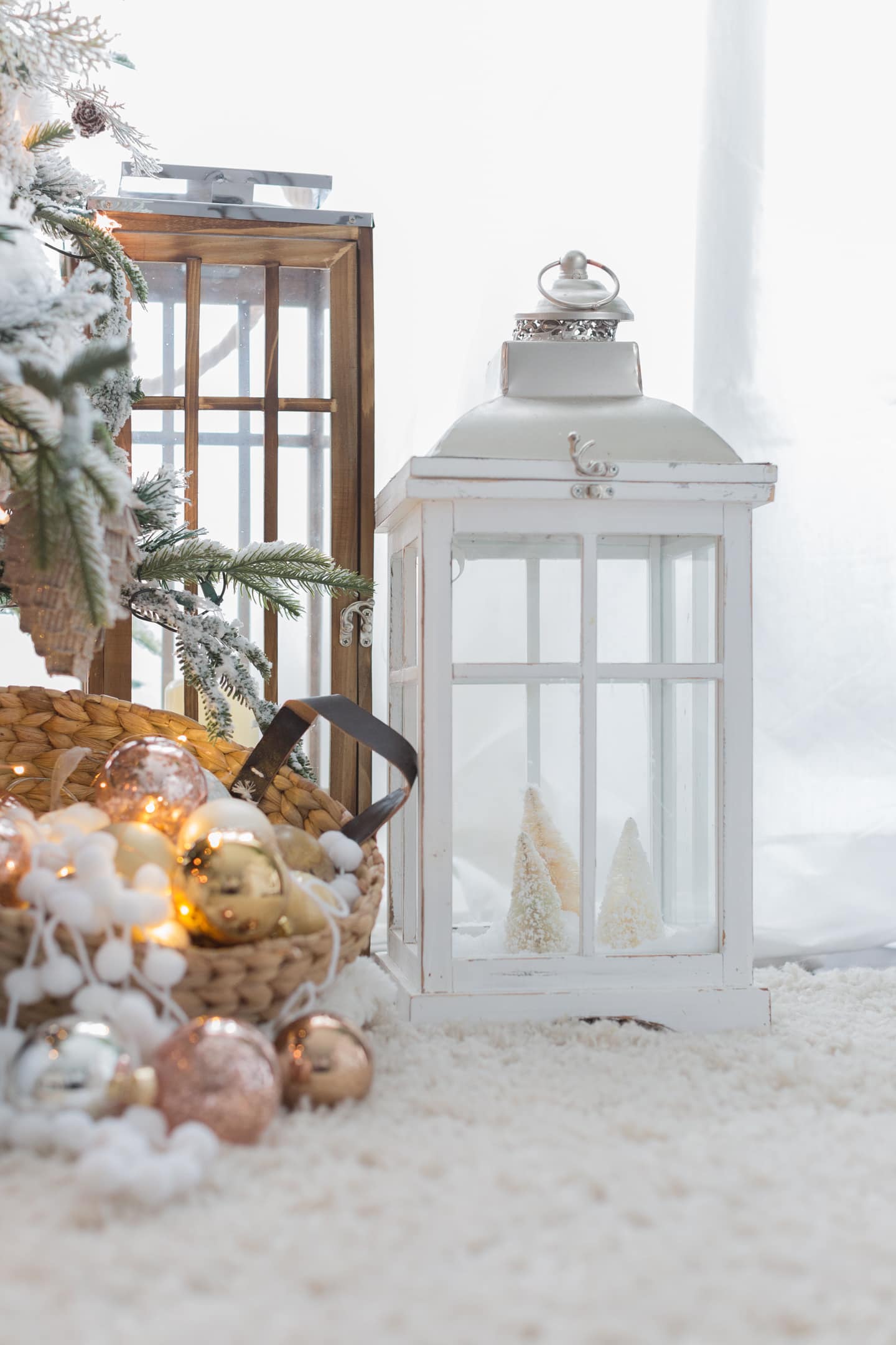 Christmas tree idea featuring a base cover next to a lantern all in white shades