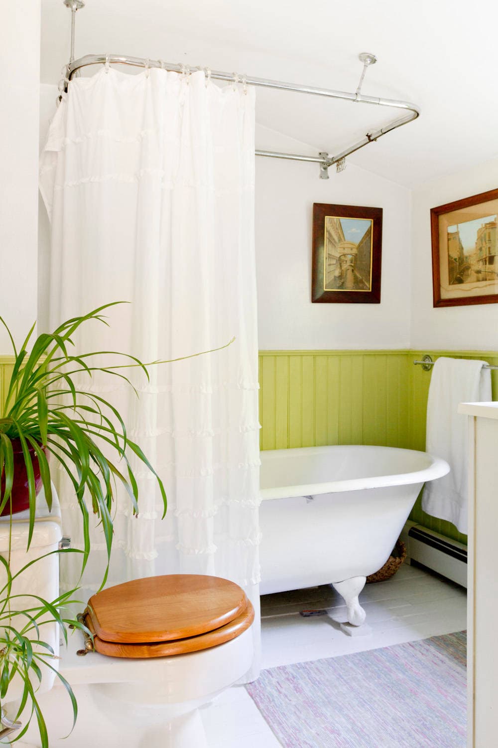 Small cottage bathroom with green half wall idea featured in home tour.